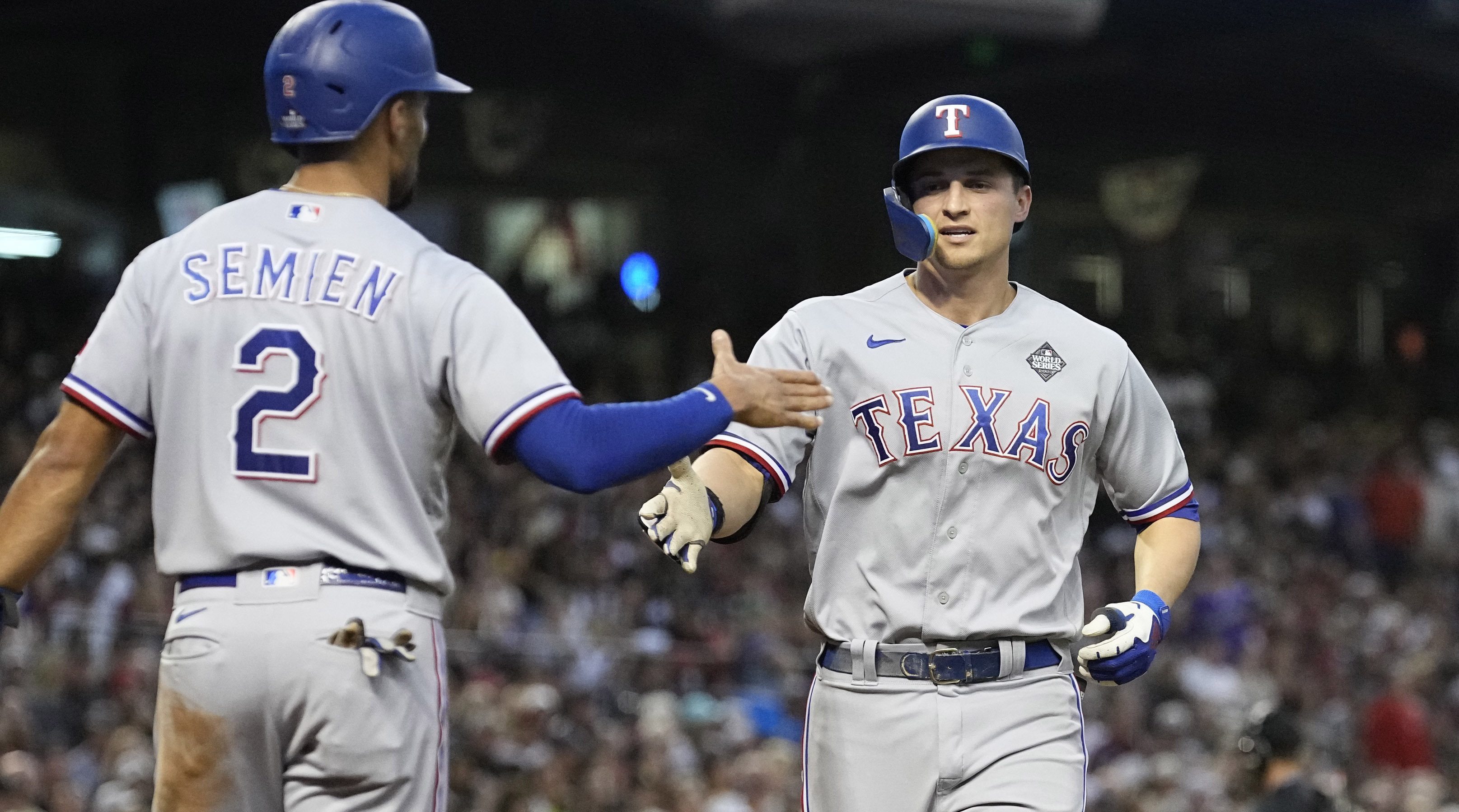 Rangers' Corey Seager, right, celebrates with Marcus Semien after both scored on Seager's home run in Game 4 of the 2023 World Series