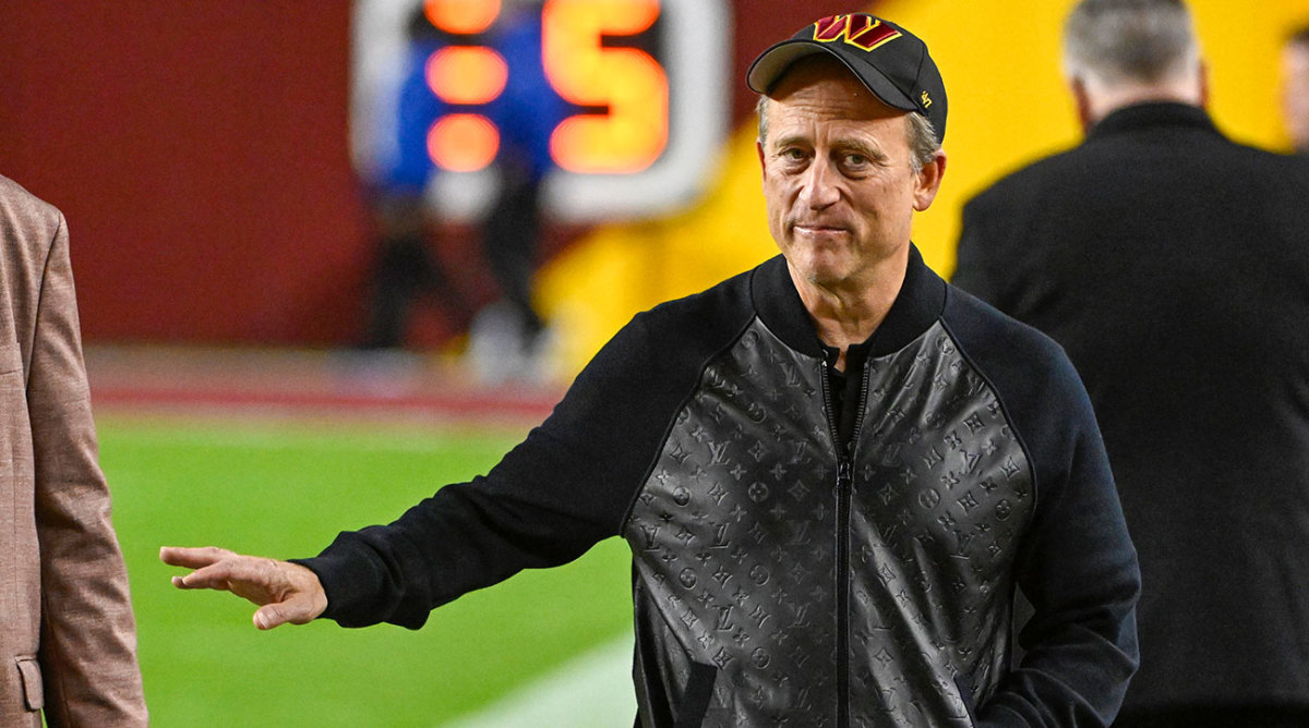 Commanders owner Josh Harris on the field before the game against the Bears.