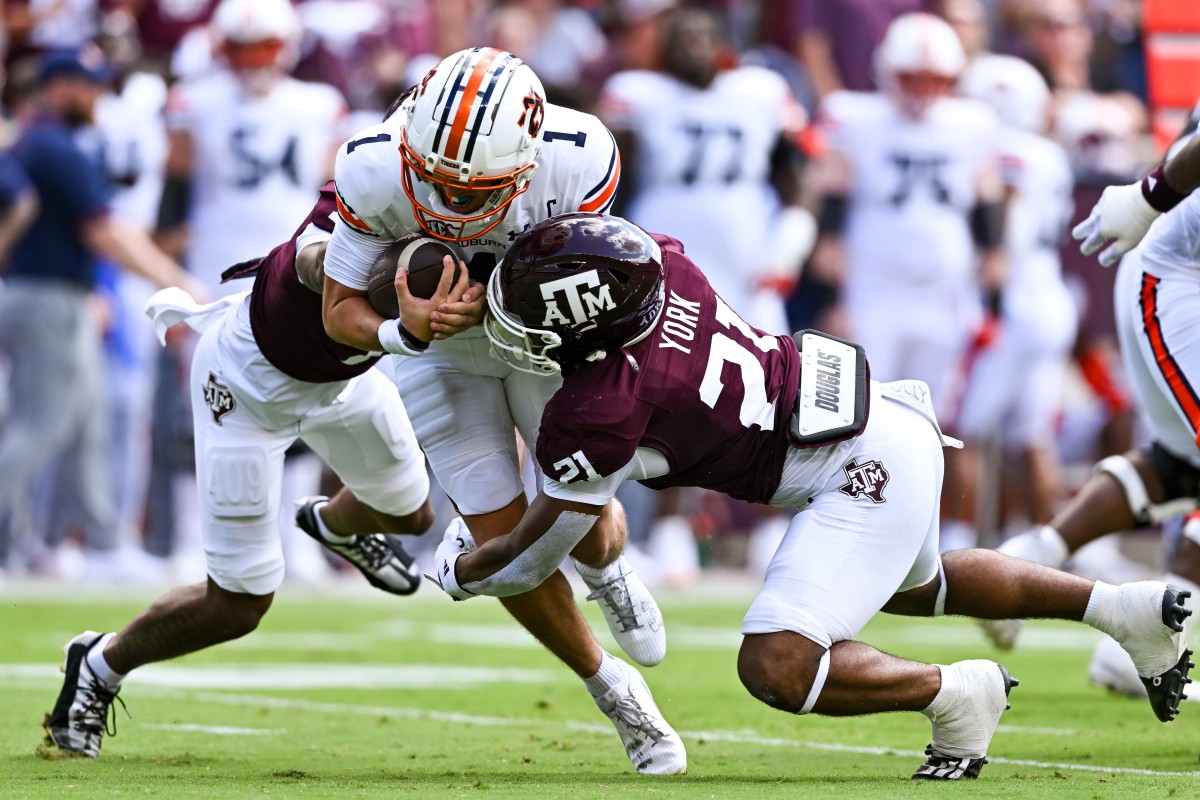 Sep 23, 2023; College Station, Texas, USA; Auburn Tigers quarterback Payton Thorne (1) is tackled by Texas A&M Aggies defensive back Bryce Anderson (1) and linebacker Taurean York (21) during the first quarter at Kyle Field.