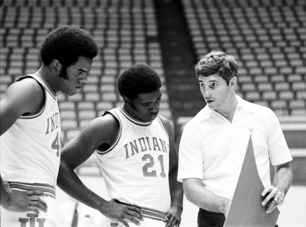 Scott May (left) and Quinn Buckner (right) listen intently to instruction from Bob Knight early in the 1974-75 season.