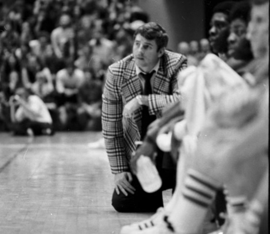 Bob Knight watches from one knee during a game at Assembly Hall in the 1975 season.