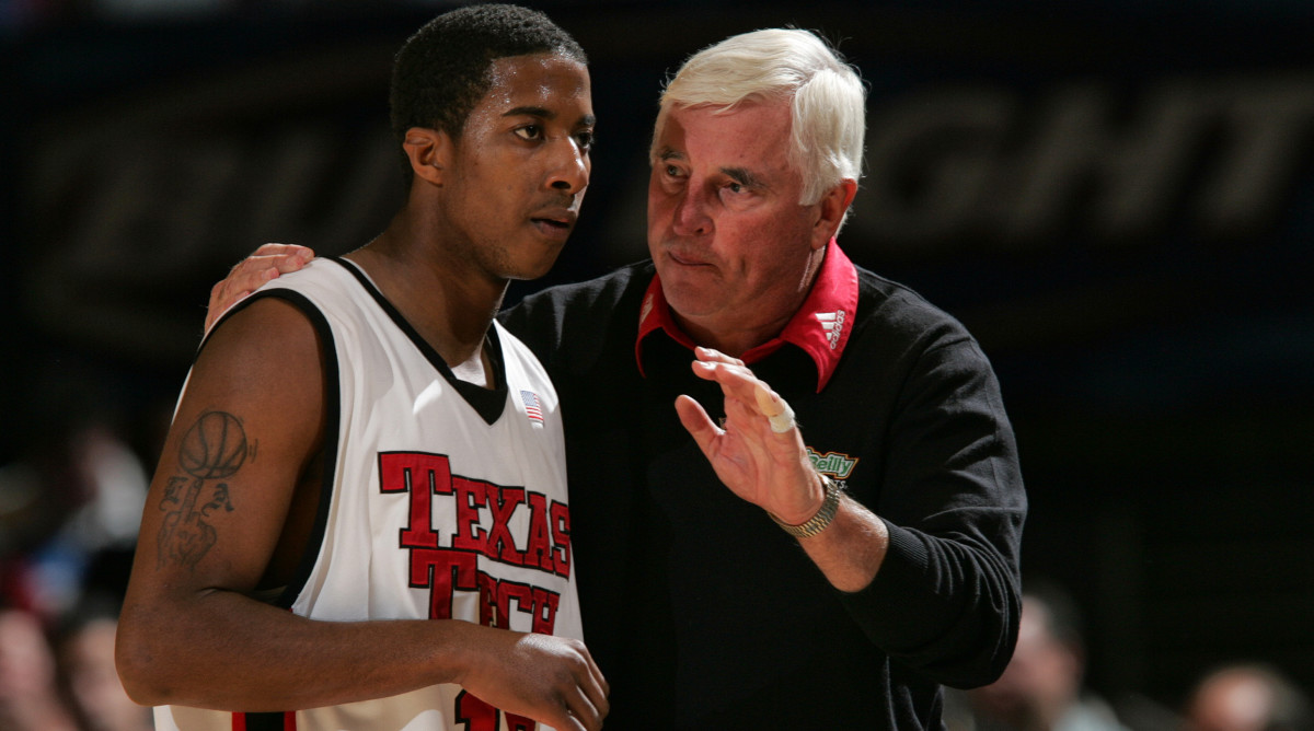 Texas Tech coach Bobby Knight instructs a player with his arm around him