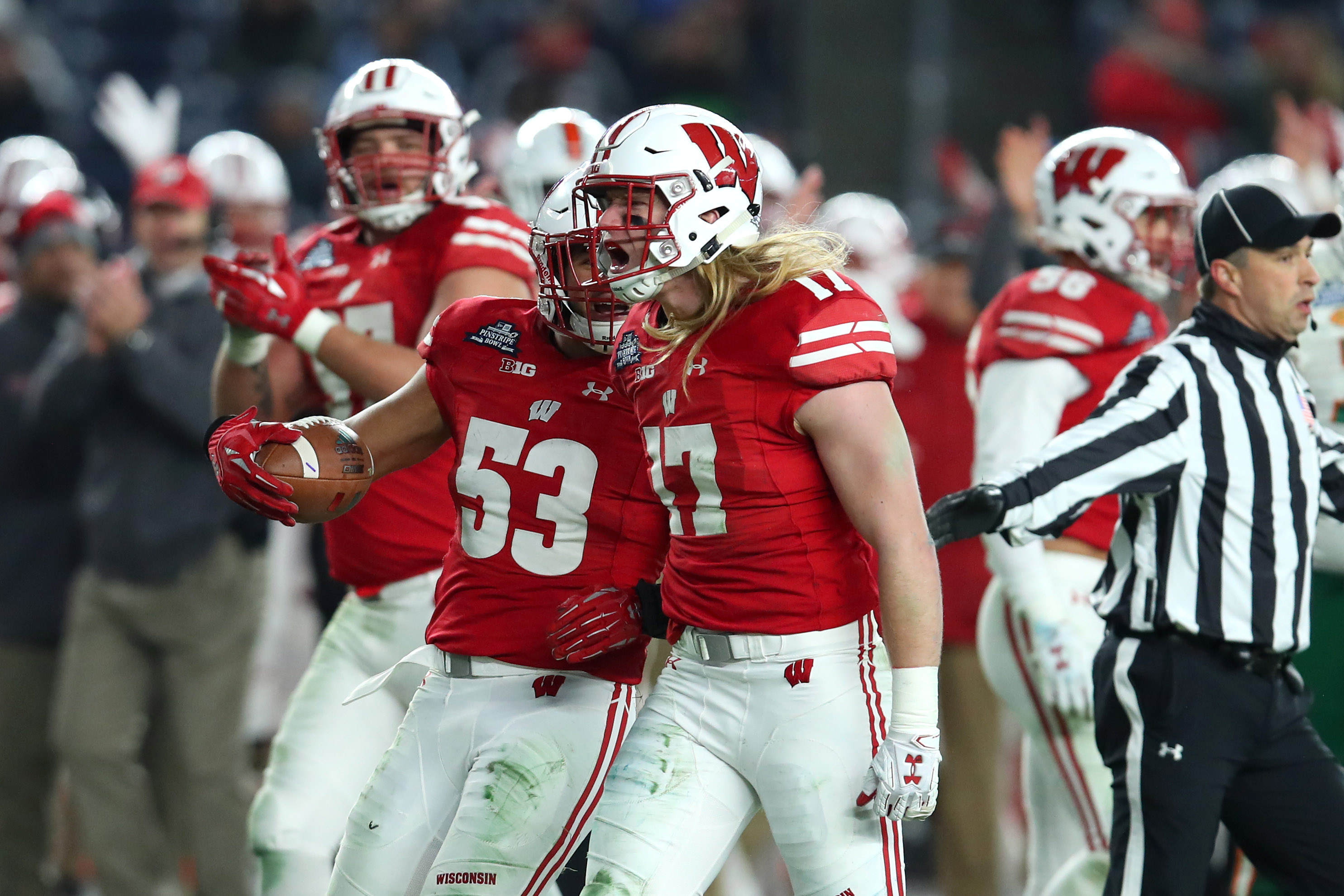 Dec 27, 2018; Bronx, NY, USA; Wisconsin Badgers linebacker Andrew Van Ginkel (17) reacts to a defensive play with teammate linebacker T.J. Edwards (53) against the Miami Hurricanes during the second quarter in the 2018 Pinstripe Bowl at Yankee Stadium. Mandatory Credit: Rich Barnes-USA TODAY Sports