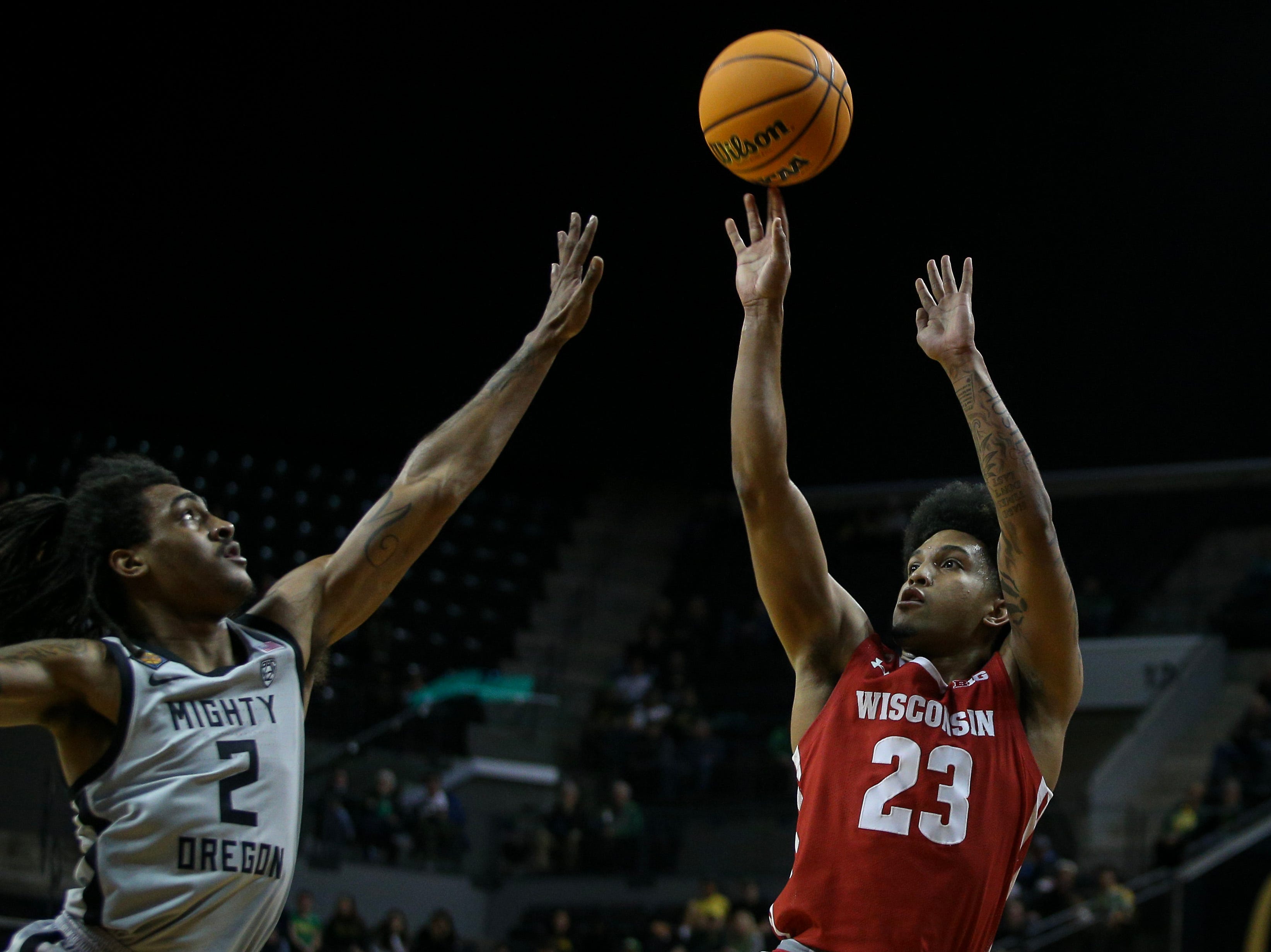 Wisconsin guard Chucky Hepburn puts up a shot under coverage from Oregon guard Tyrone Williams as the Oregon Ducks host Wisconsin in the quarterfinal round of the NIT Tuesday, March 21, 2023 at Matthew Knight Arena in Eugene, Ore. Ncaa Basketball Wisconsin At Oregon Mbb Nit Wisconsin At Oregon