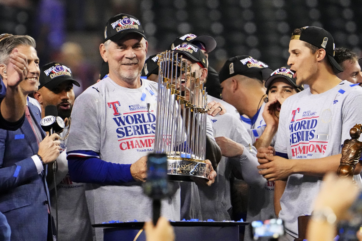 Texas Rangers manager Bruce Bochy celebrates with the Commissioner's Trophy after the Texas Rangers beat the Arizona Diamondbacks to win the World Series in Game 5 of the 2023 World Series Wednesday at Chase Field in Phoenix.