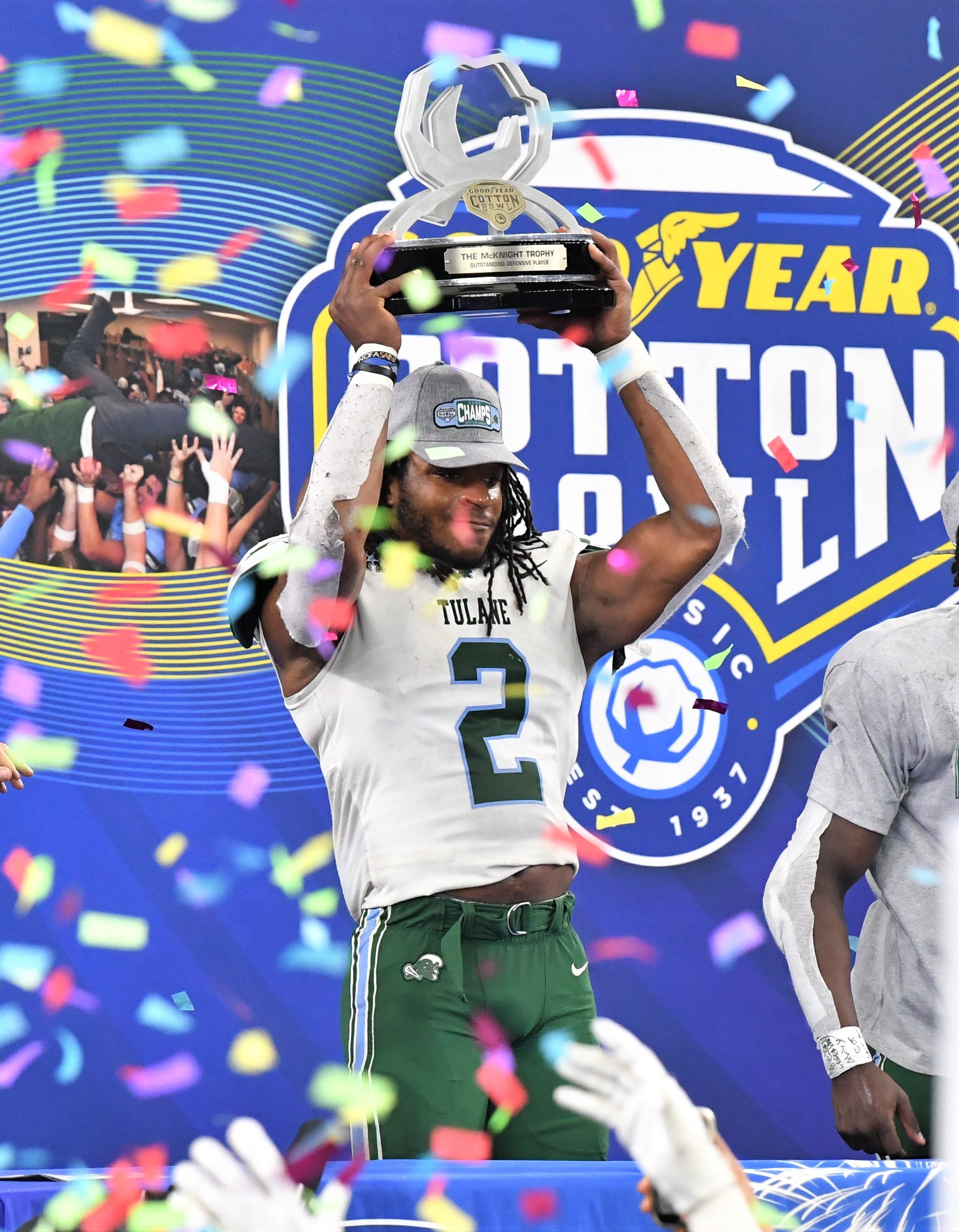 Tulane's Dorian Williams hoists his \"Outstanding Defensive Player\" trophy during the celebration after Tulane defeated USC during the 87th Goodyear Cotton Bowl Classic at AT&T Stadium on Monday, January 2, 2023. COTTONBOWL Syndication Times Record News
