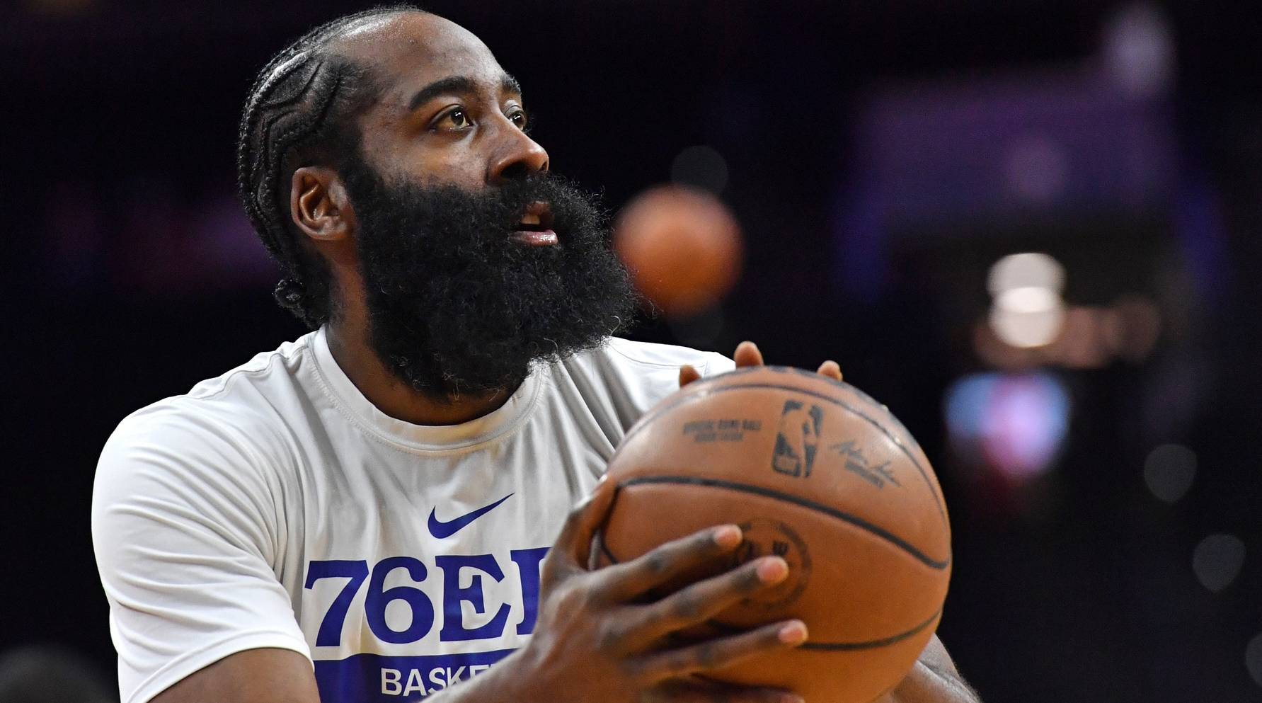 76ers point guard James Harden shoots a shot in warmups before a game.