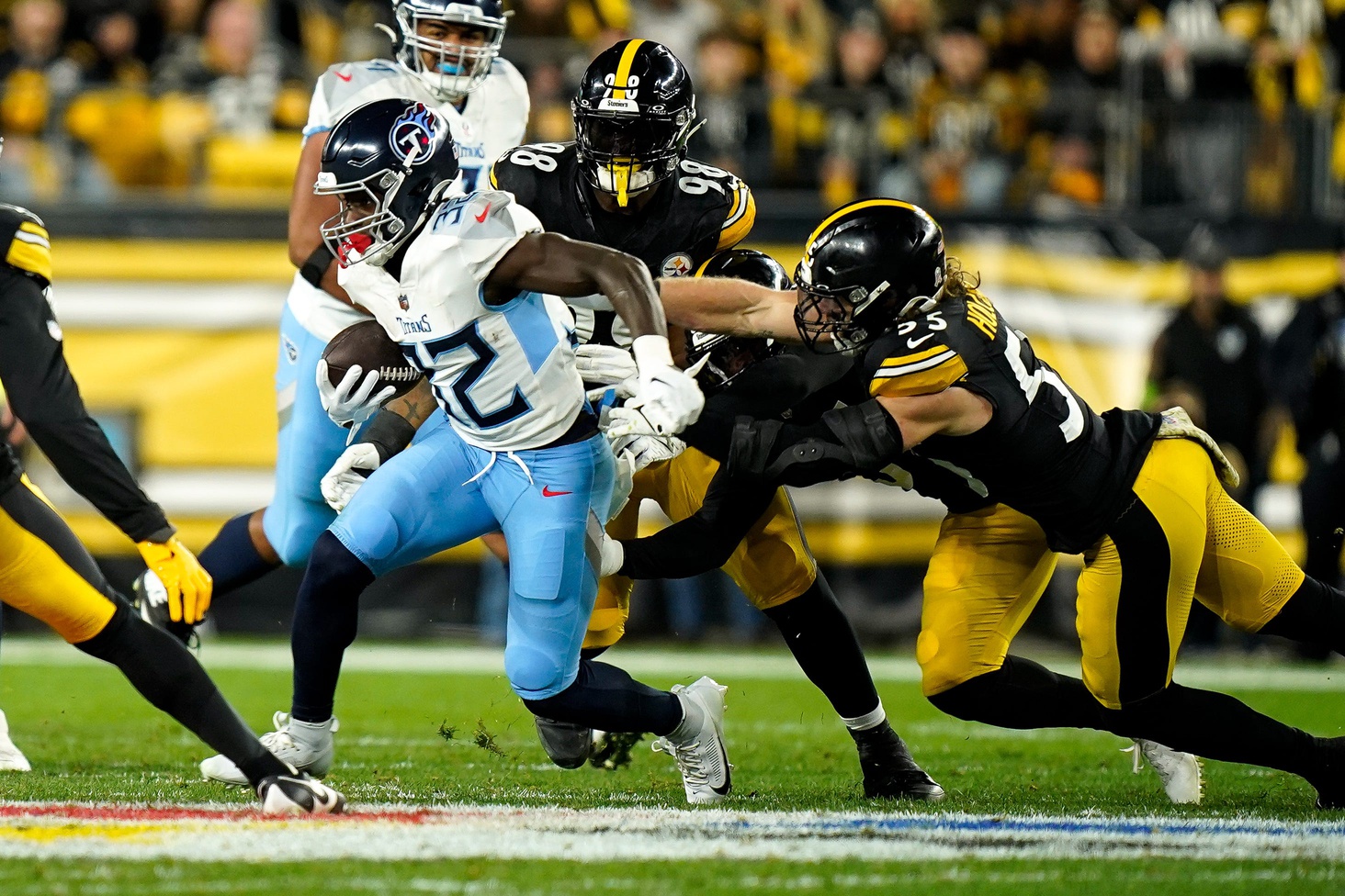 Tennessee Titans running back Tyjae Spears (32) runs the ball past Pittsburgh Steelers linebacker Cole Holcomb (55) during the first quarter.