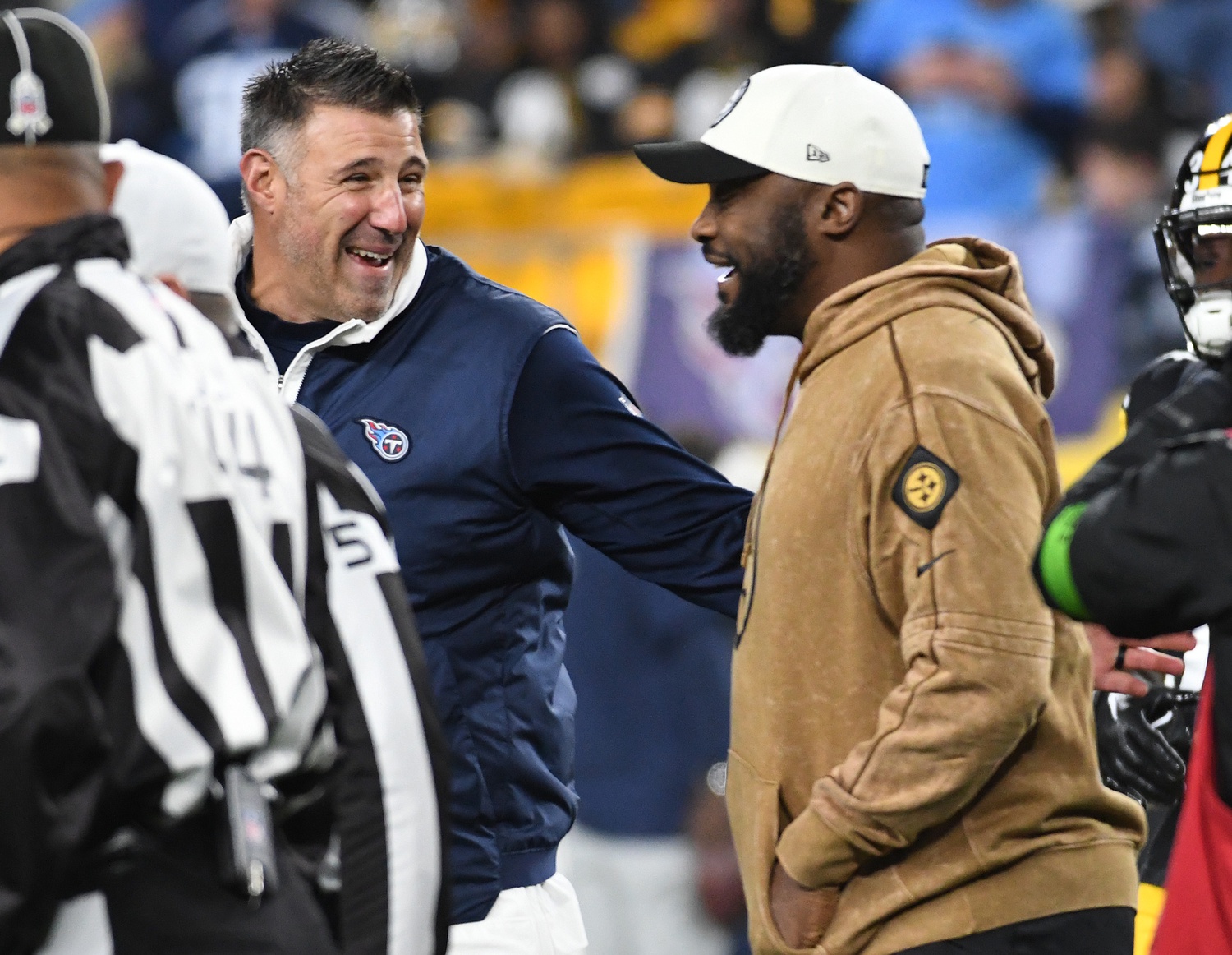 Tennessee Titans head coach Mike Vrabel (left) meets with Pittsburgh Steelers head coach Mike Tomlin before the game at Acrisure Stadium.