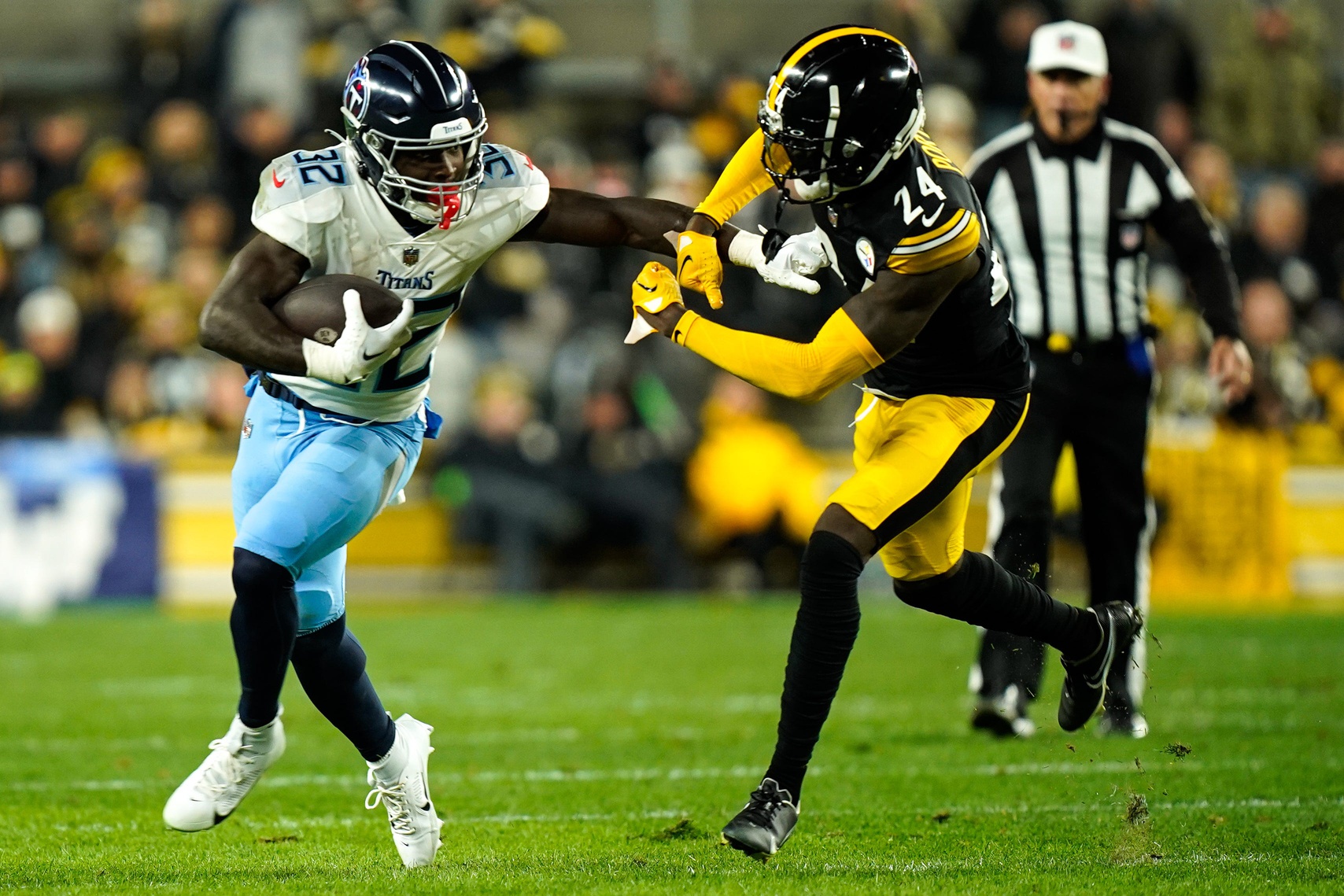 Tennessee Titans running back Tyjae Spears (32) evades Pittsburgh Steelers cornerback Joey Porter Jr. (24) during the first quarter.