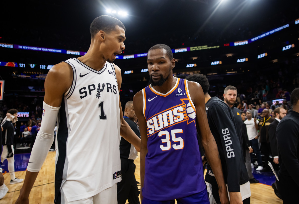Victor Wembanyama and Kevin Durant meet at midcourt after Wemby's 38-point effort pushed the Spurs past the Suns.