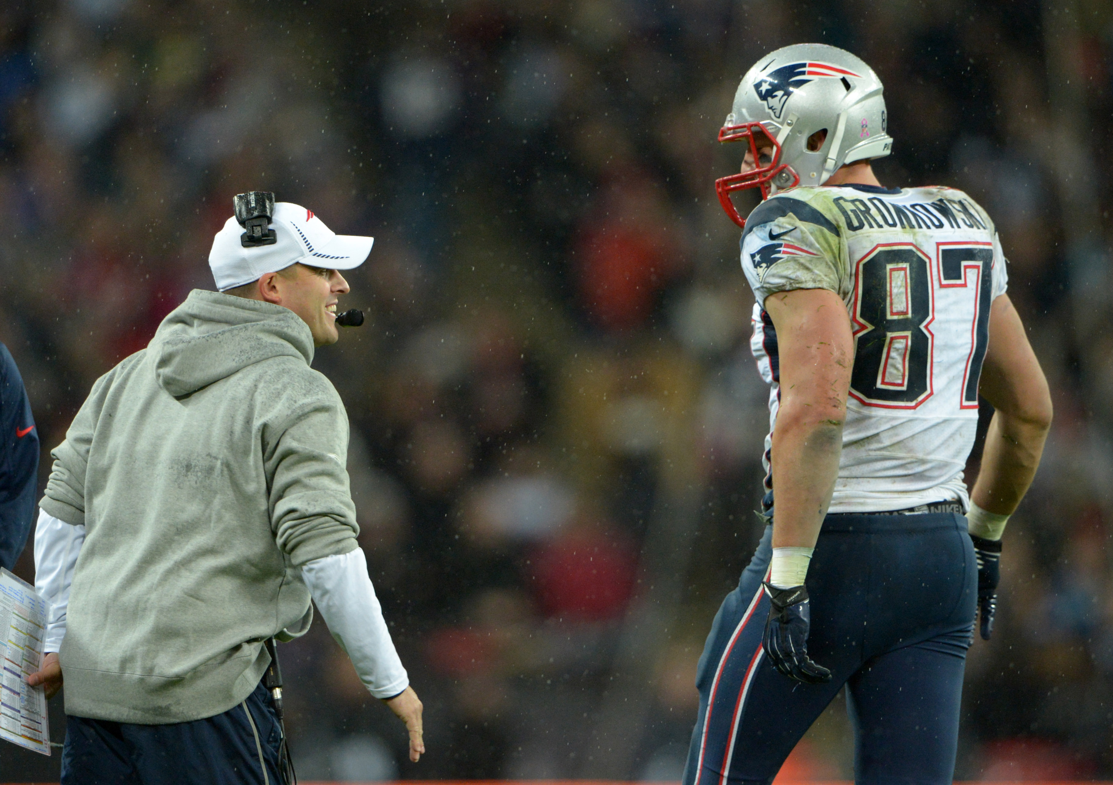 Oct 28,2012; London, UNITED KINGDOM; New England Patriots tight end Rob Gronkowski (87) is congratulated by offensive coordinator Josh McDaniels after scoring on a 14-yard touchdown pass in the fourth quarter against the St. Louis Rams in the 2012 NFL International Series game at Wembley Stadium. The Patriots defeated the Rams 45-7.  