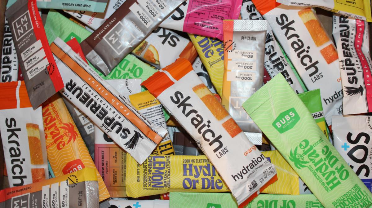 A pile of electrolyte powder packets, including Skratch Labs, Bubs, LMNT and more