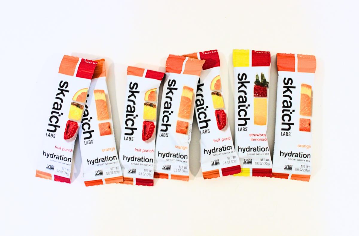 Skratch Labs hydration electrolyte travel packets in various flavors against a white background