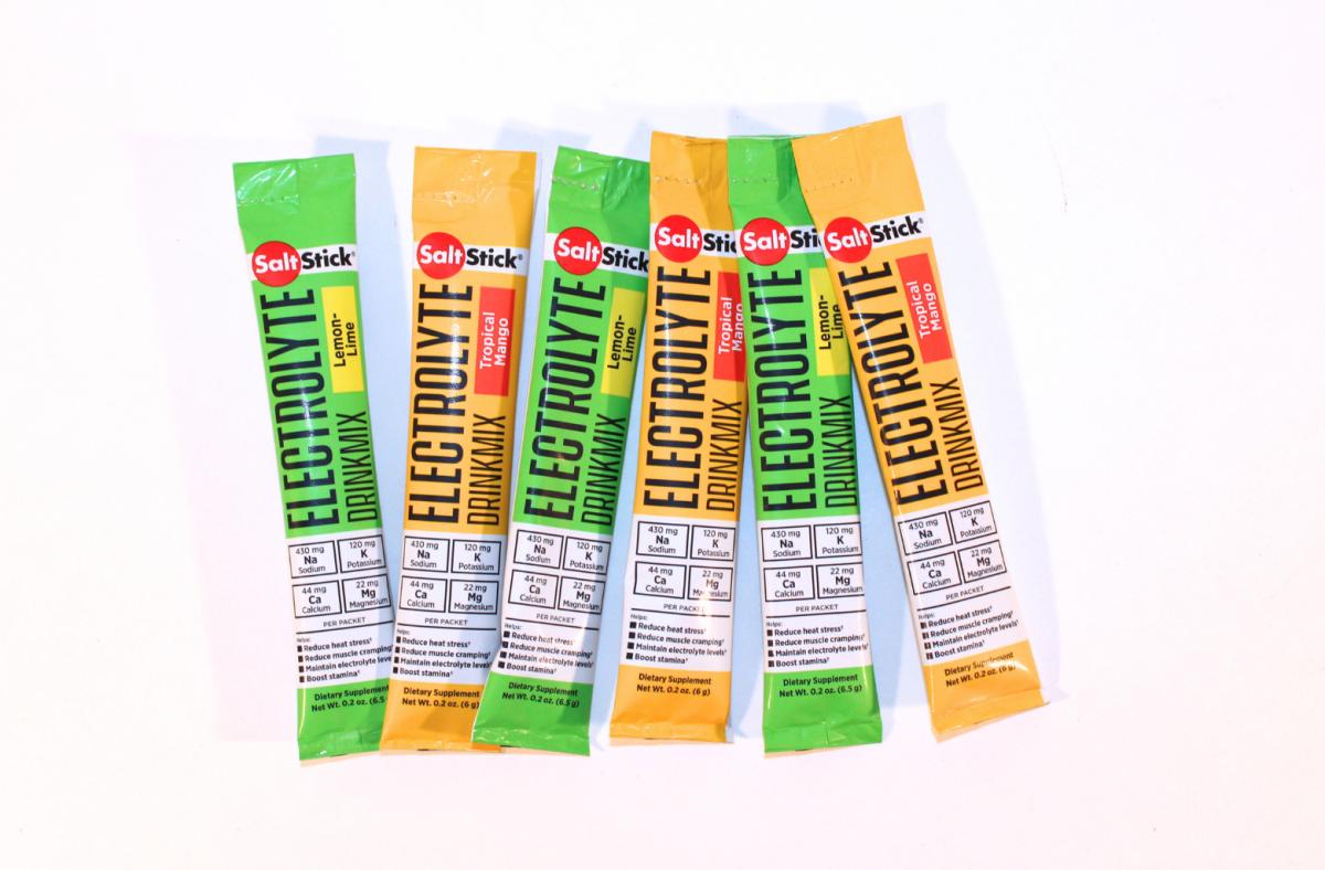 SaltStick Electrolyte travle packets in Tropical Mango and Lemon Lime flavors against a white background