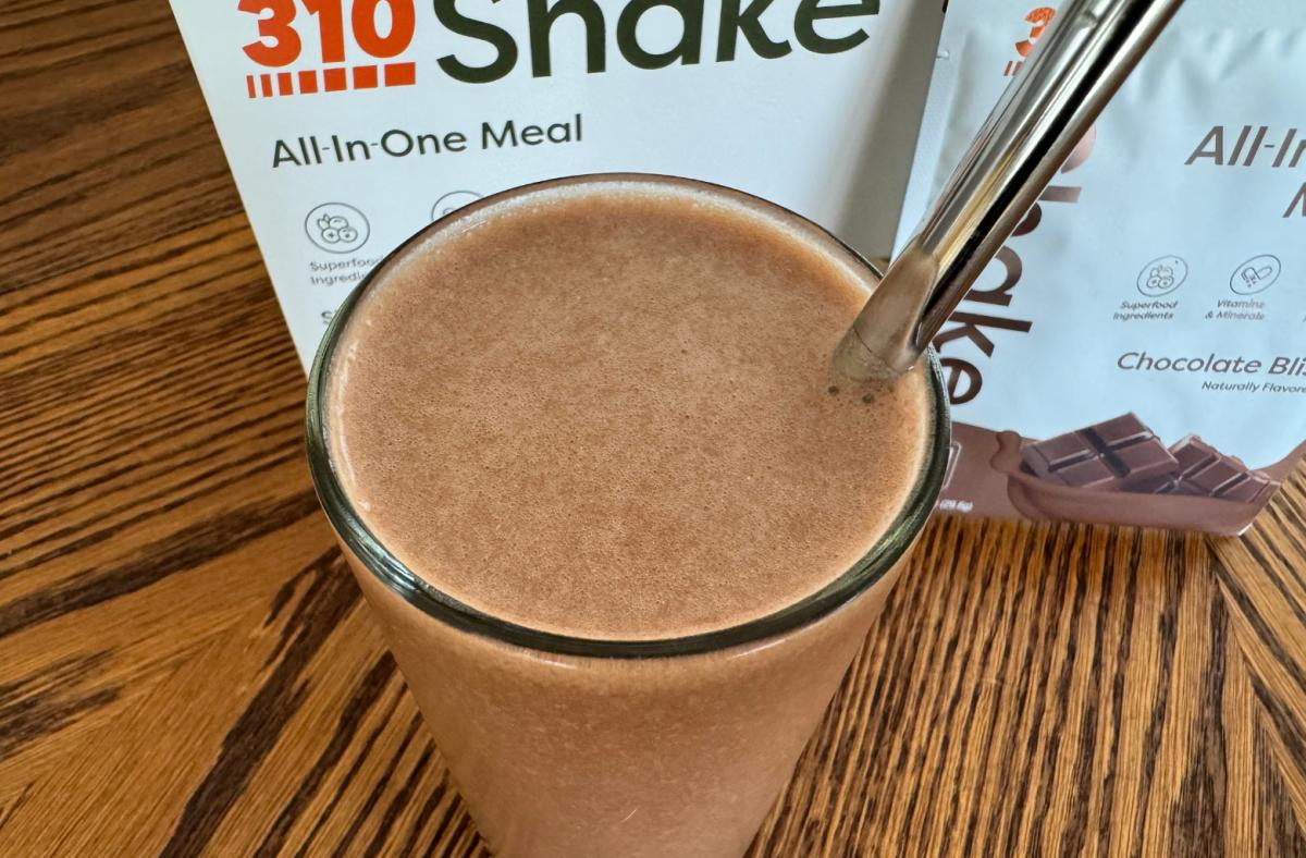 A 310 Meal Replacement Shake in chocolate flavor in a glass
