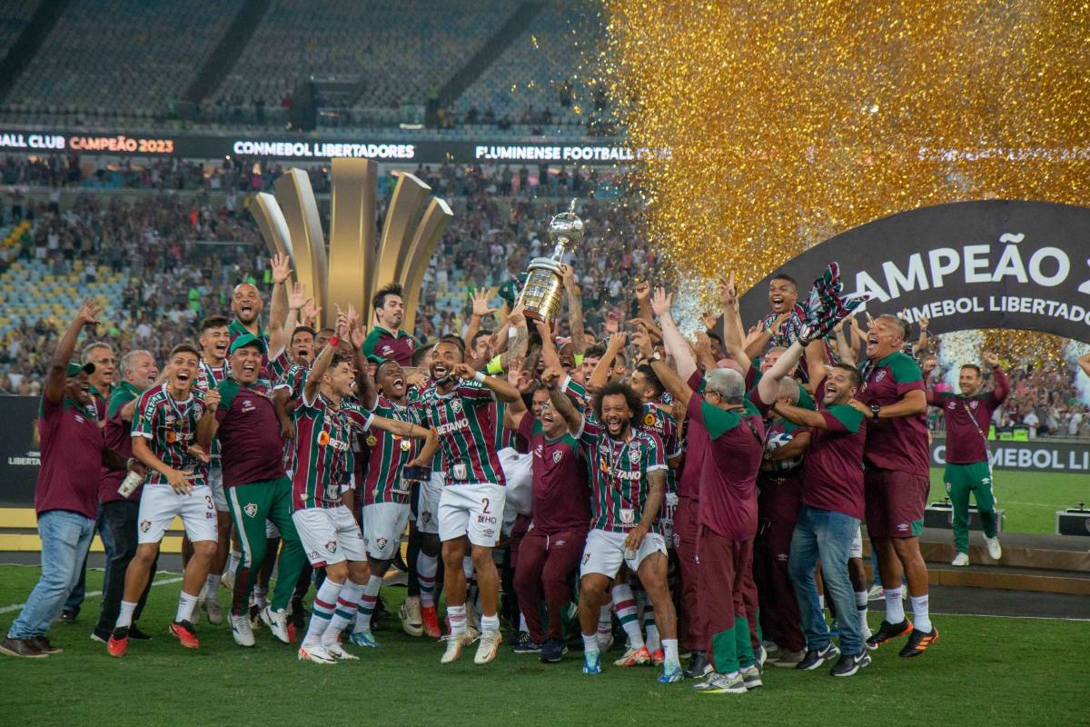 Players and coaches of Fluminense pictured celebrating with the Copa Libertadores trophy after beating Boca Juniors in the 2023 final