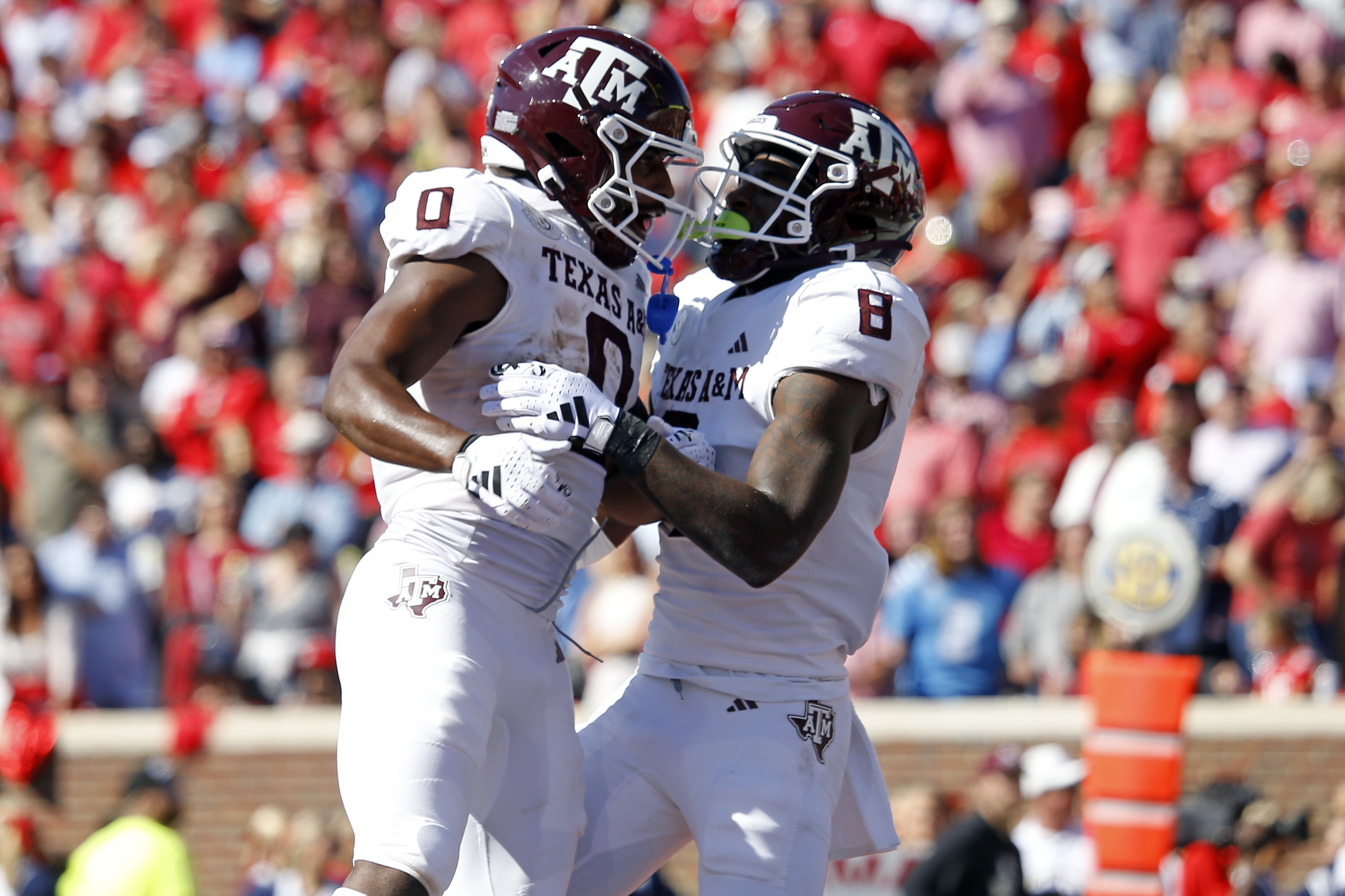 Nov 4, 2023; Oxford, Mississippi, USA; Texas A&M Aggies wide receiver Ainias Smith (0) and running back Le'Veon Moss (8) react after a touchdown during the first half at Vaught-Hemingway Stadium.