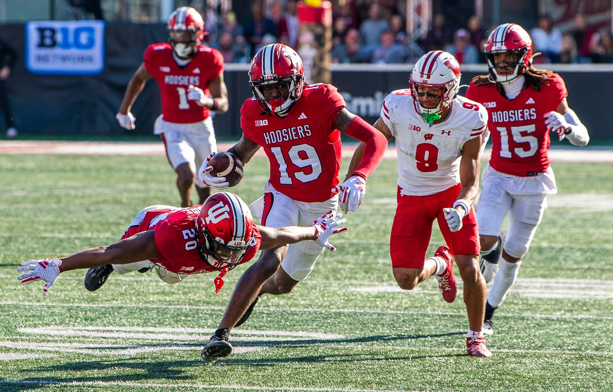 Nov 4, 2023; Bloomington, Indiana, USA; Indiana's Louis Moore (20) starts to celebrate as Josh Sanguinetti runs back a fumble during the second half of a victory over the Wisconsin Badgers during the second half at Memorial Stadium. Mandatory Credit: Rich Janzaruk-USA TODAY Sports