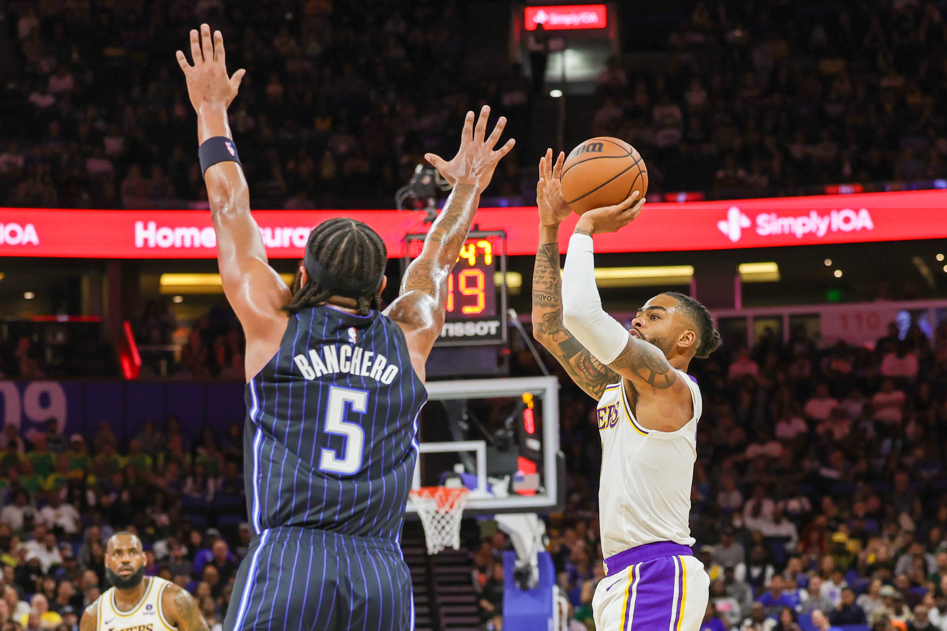 Orlando Magic forward Paolo Banchero (5) contests a shot from Los Angeles Lakers guard D'Angelo Russell