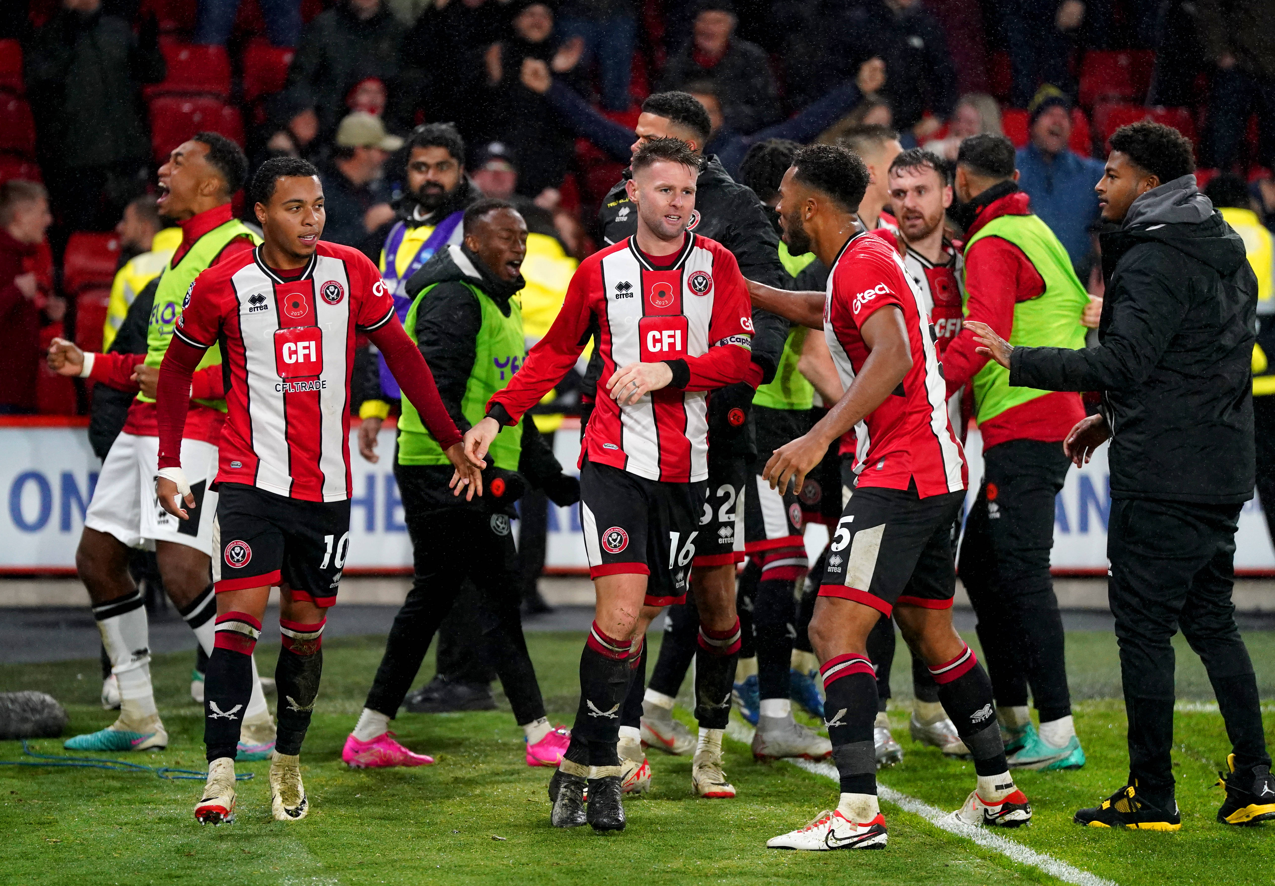 Sheffield United players pictured celebrating after scoring a late goal to beat Wolves 2-1 in November 2023