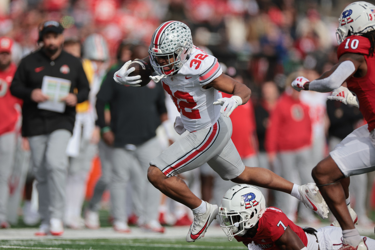 Ohio State running back TreVeyon Henderson breaks tackle against Rugters