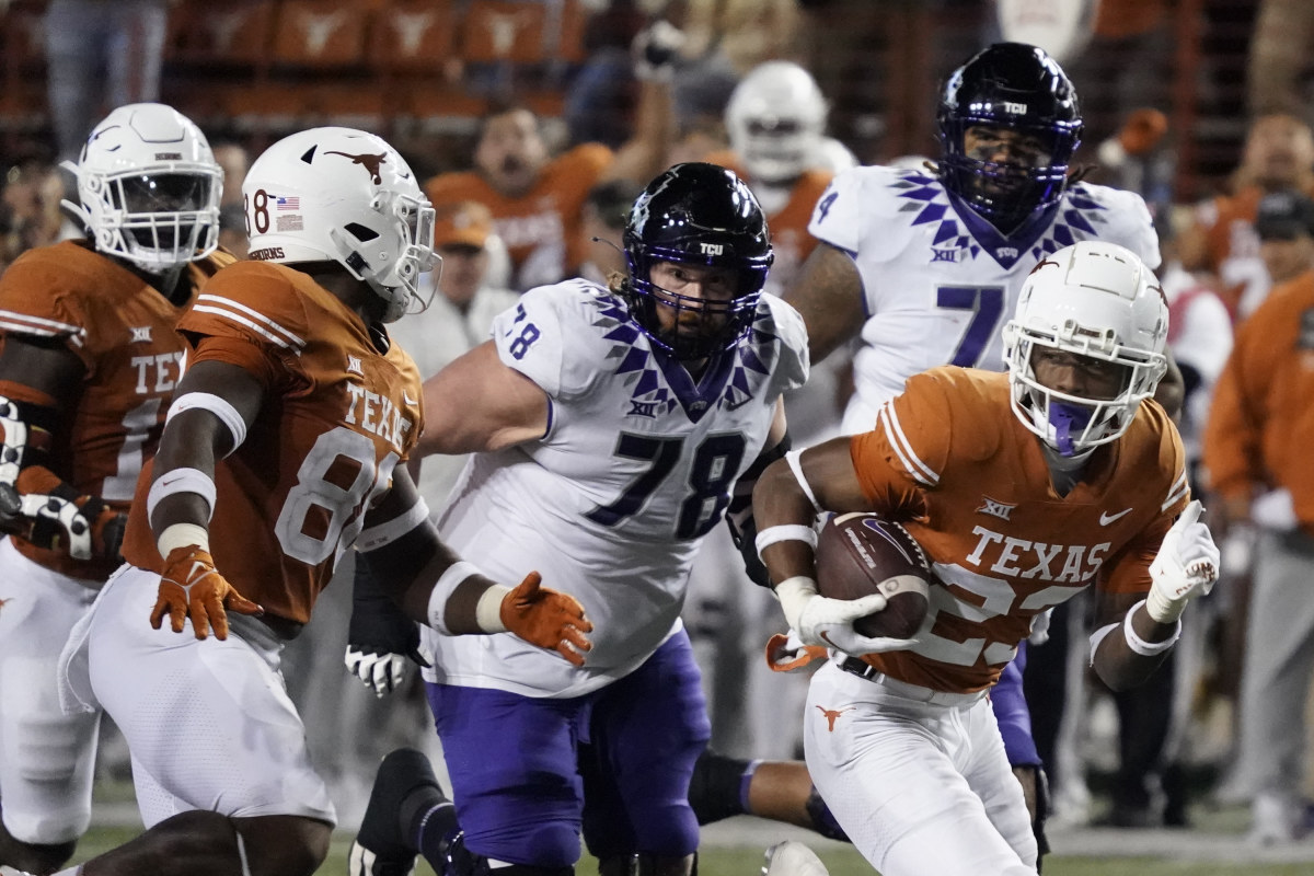 Texas Longhorns defensive back Jahdae Barron (23) runs for a touchdown after recovering a fumble against the Texas Christian Horned Frogs during the second half at Darrell K Royal-Texas Memorial Stadium.