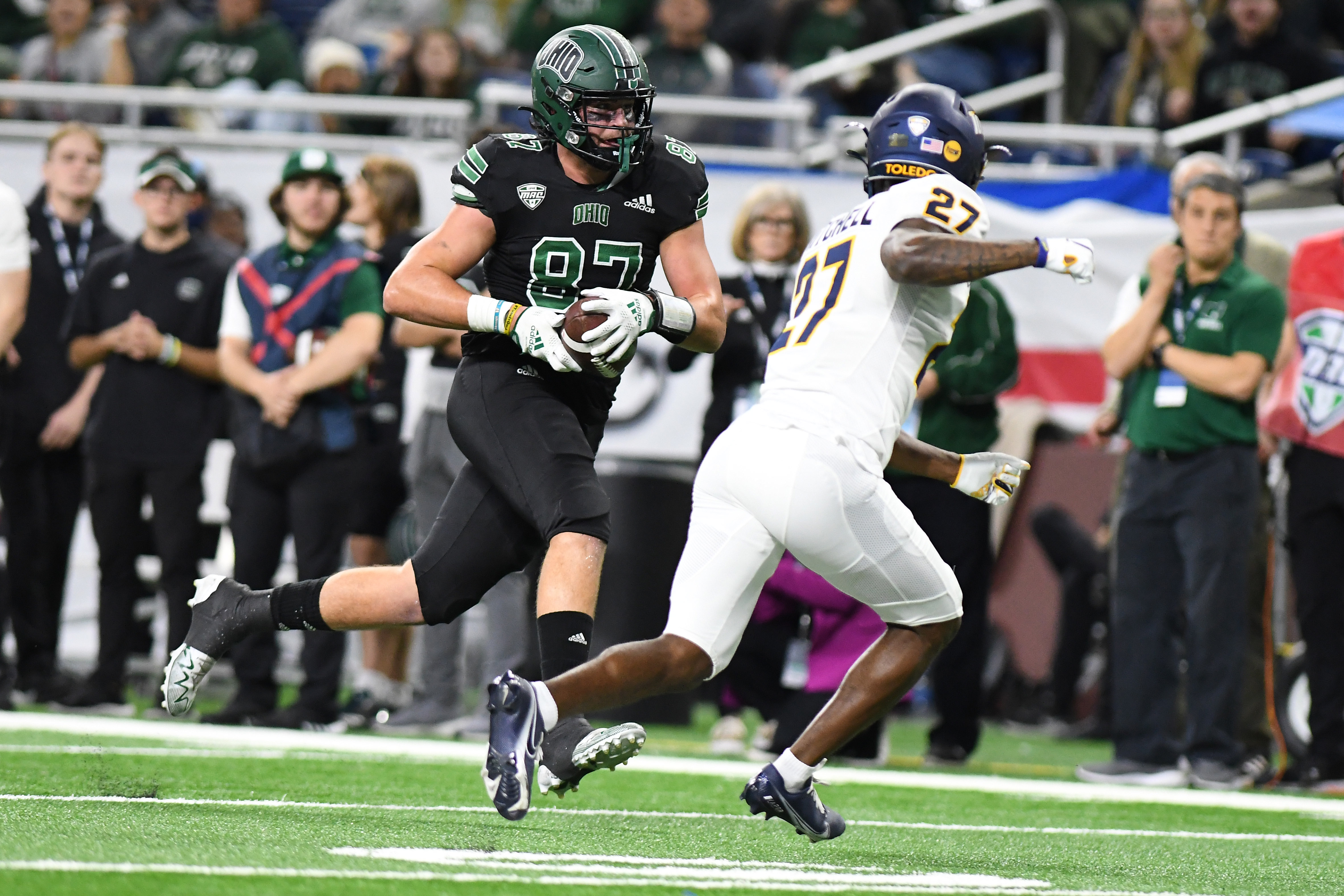 Dec 3, 2022; Detroit, Michigan, USA; Ohio University tight end Will Kacmarek (87) runs upfield after catching a pass as Toledo cornerback Quinyon Mitchell (27) closes in the second quarter at Ford Field. Mandatory Credit: Lon Horwedel-USA TODAY Sports