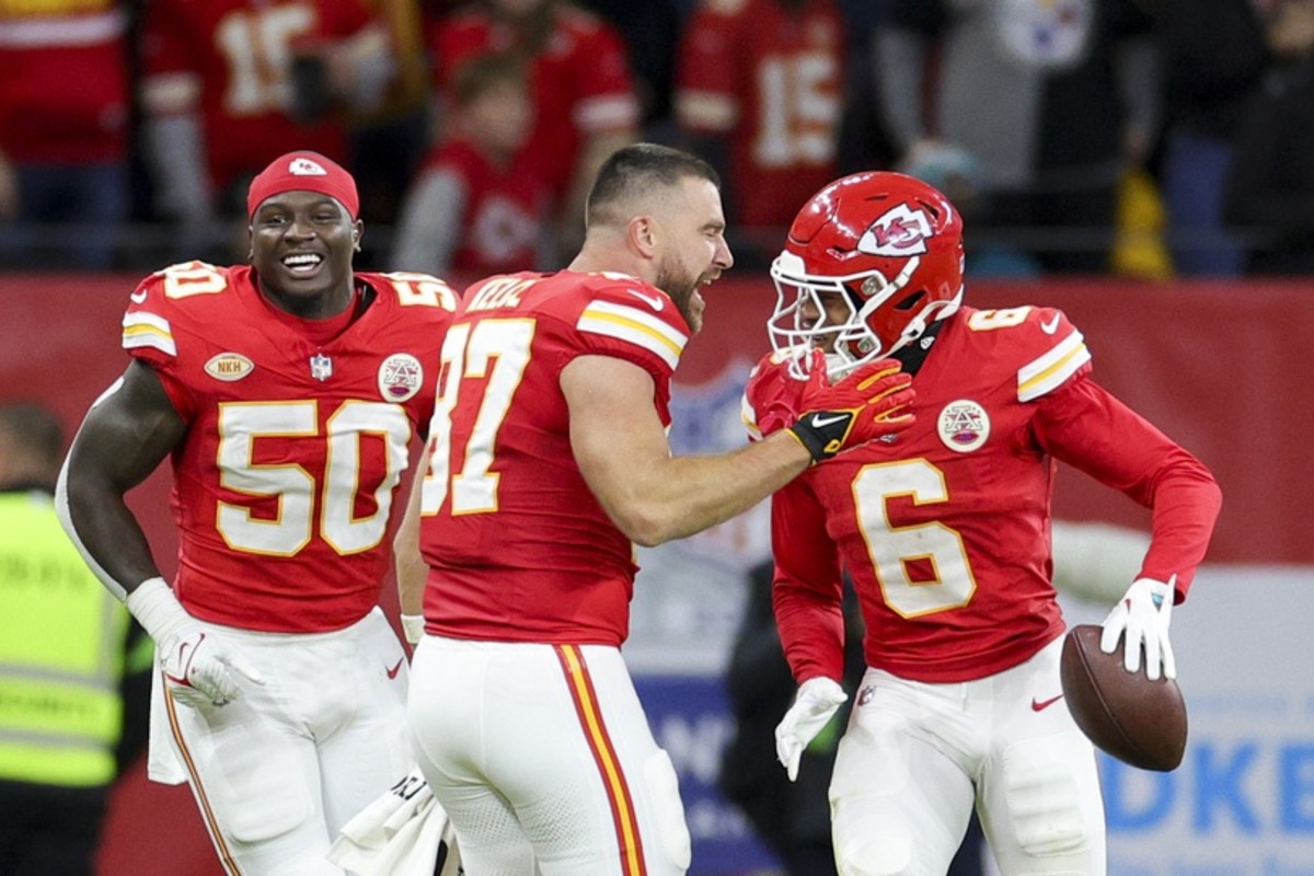 Chiefs tight end Travis Kelce celebrates with Bryan Cook after Cook's 59-yard fumble return for a touchdown in Week 9 against the Dolphins.