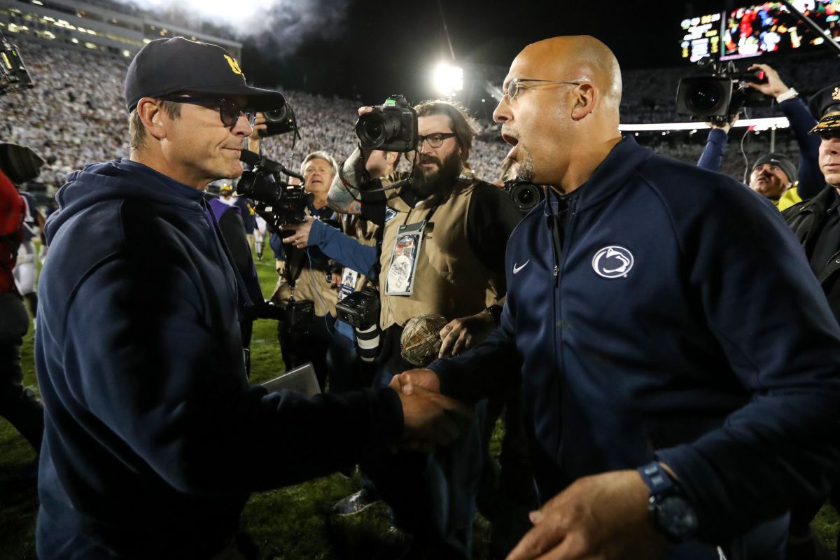 Penn State coach James Franklin greets Michigan coach Jim Harbaugh after their 2019 game at Beaver Stadium.