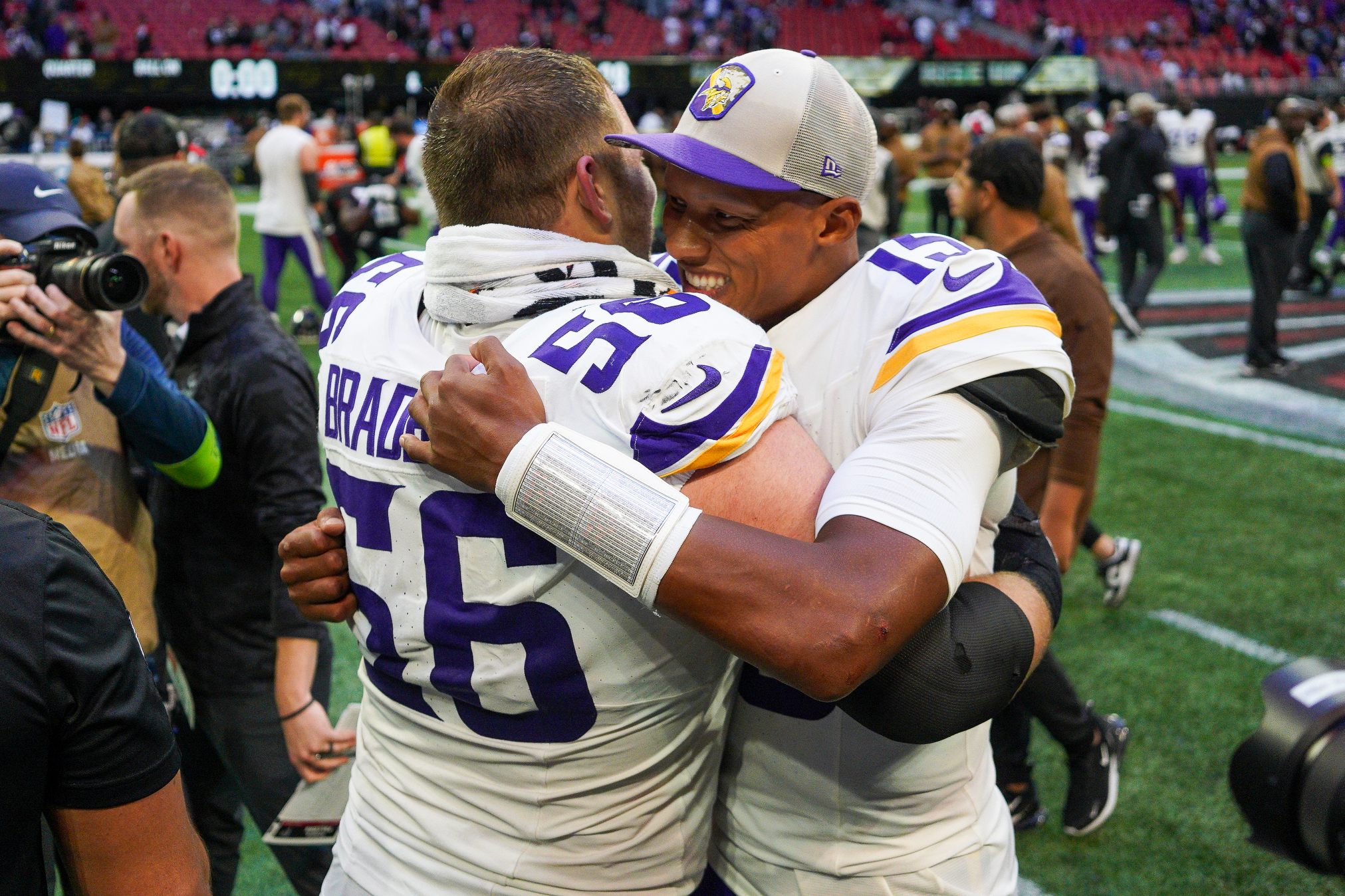 Nov 5, 2023; Atlanta, Georgia, USA; Minnesota Vikings center Garrett Bradbury (56) and quarterback Joshua Dobbs (15) hug after a victory against the Atlanta Falcons at Mercedes-Benz Stadium. 