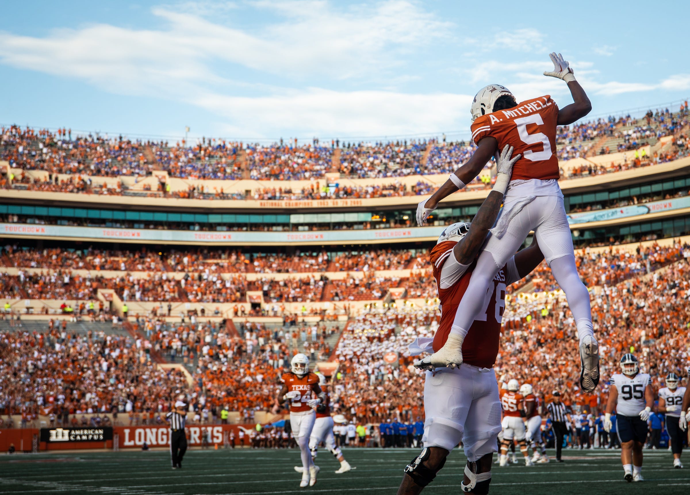 Texas offensive lineman Kelvin Banks Jr. (78) lifts Texas wide receiver Adonai Mitchell (5) after his touchdown in the fourth quarter of the Longhorns' game against the BYU Cougars at Darrell K Royal-Texas Memorial Stadium in Austin, Saturday, Oct. 28, 2023. Texas won the game 35-6.
