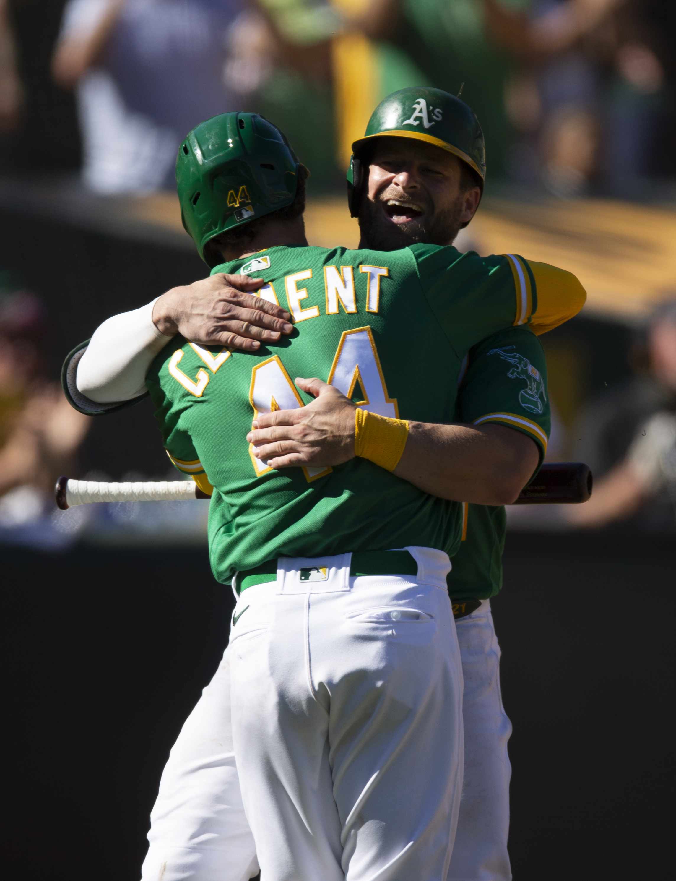 Oct 5, 2022; Oakland, California, USA; Oakland Athletics catcher Stephen Vogt (facing) gets a hug from teammate Ernie Clement (44) after hitting a solo home run against the Los Angeles Angels during the seventh inning at RingCentral Coliseum.
