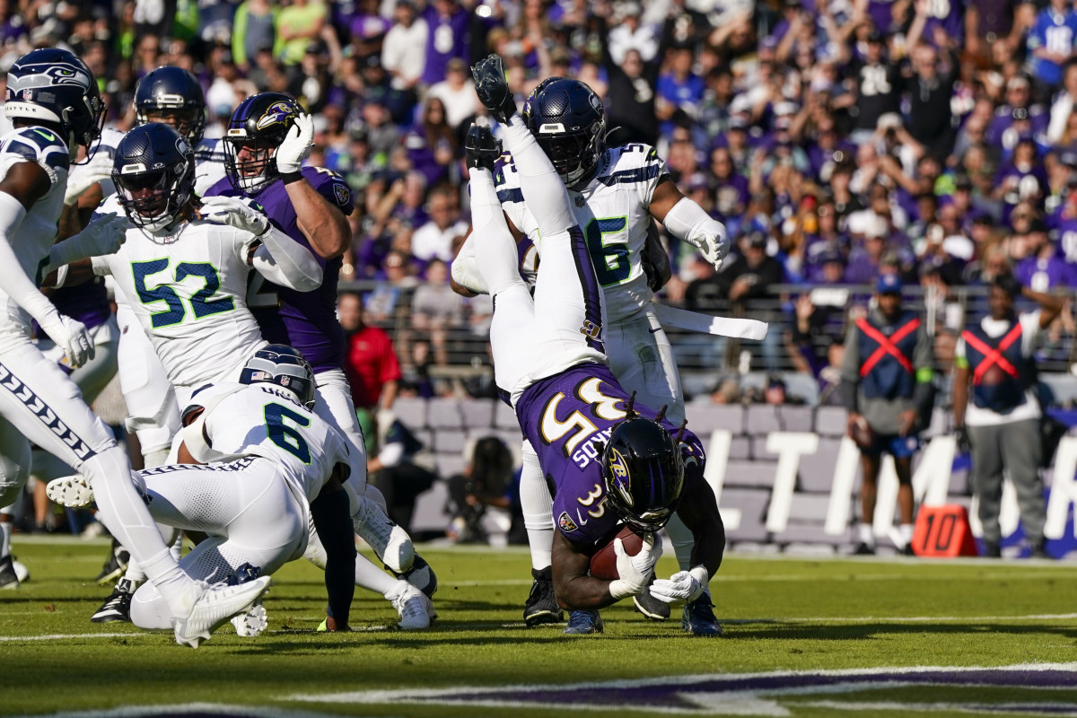 Baltimore Ravens running back Gus Edwards (35) dives into the end zone for a touchdown against the Seattle Seahawks during the first half at M&T Bank Stadium.
