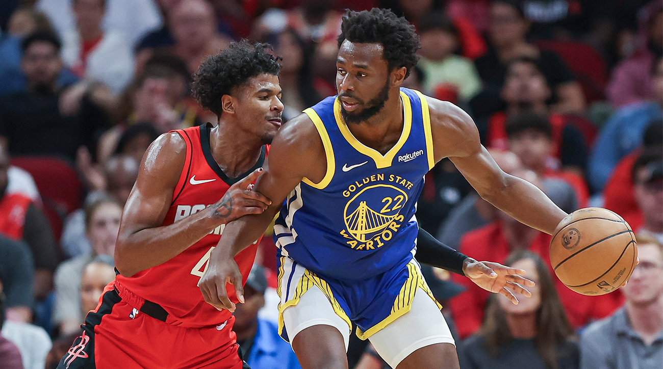 Warriors’ Andrew Wiggins posts up Rockets’ Jalen Green.