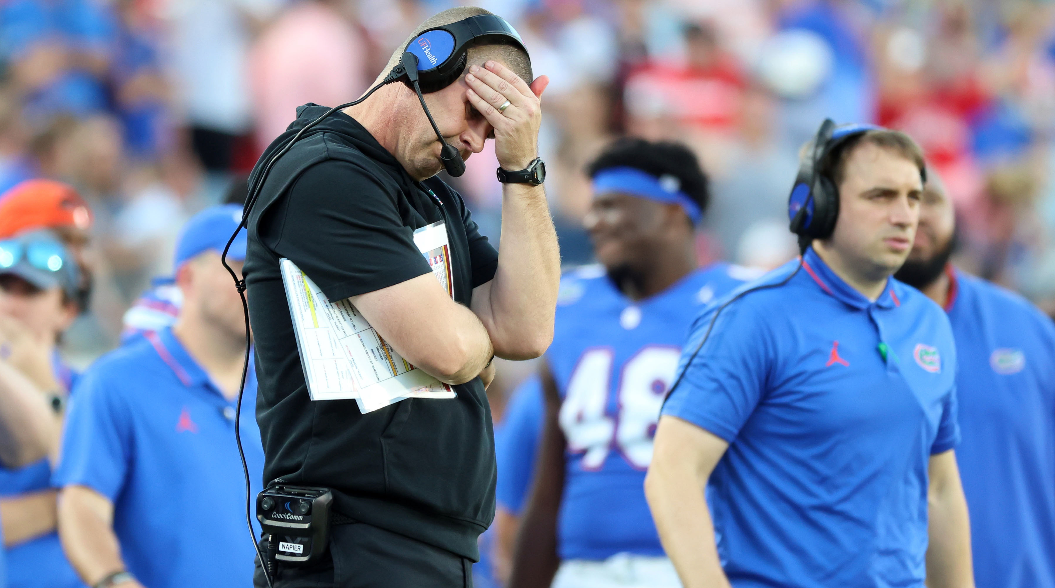 Florida Gators head coach Billy Napier reacts against the Georgia Bulldogs by cover his head with his hand.