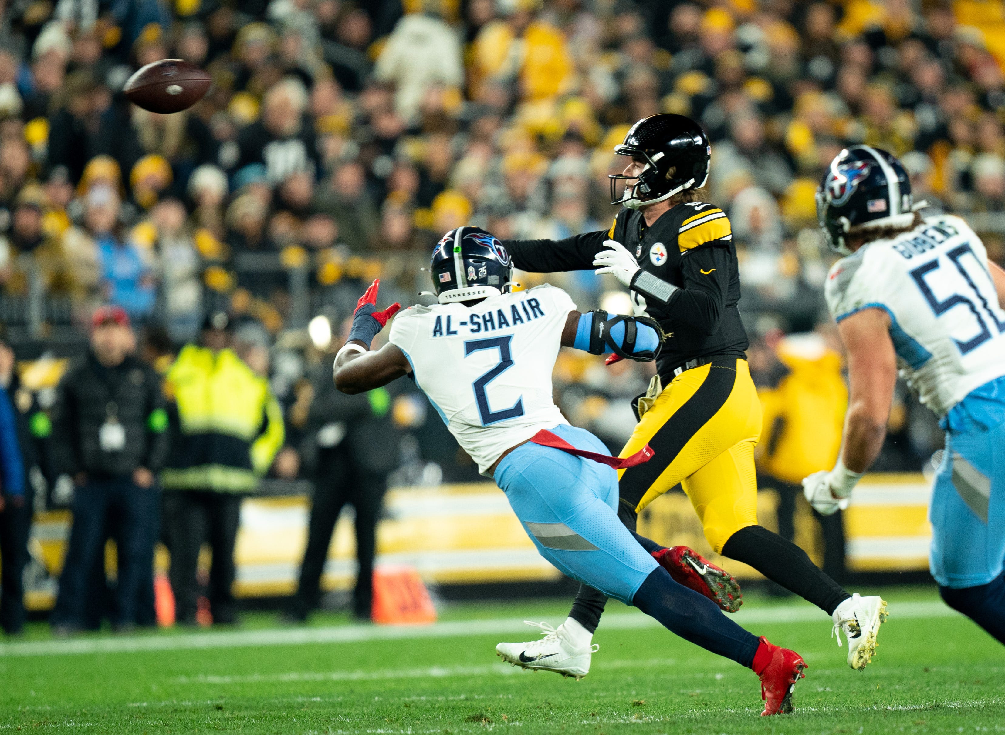 Kenny Pickett throws as Titans linebacker Azeez Al-Shaair lunges toward him