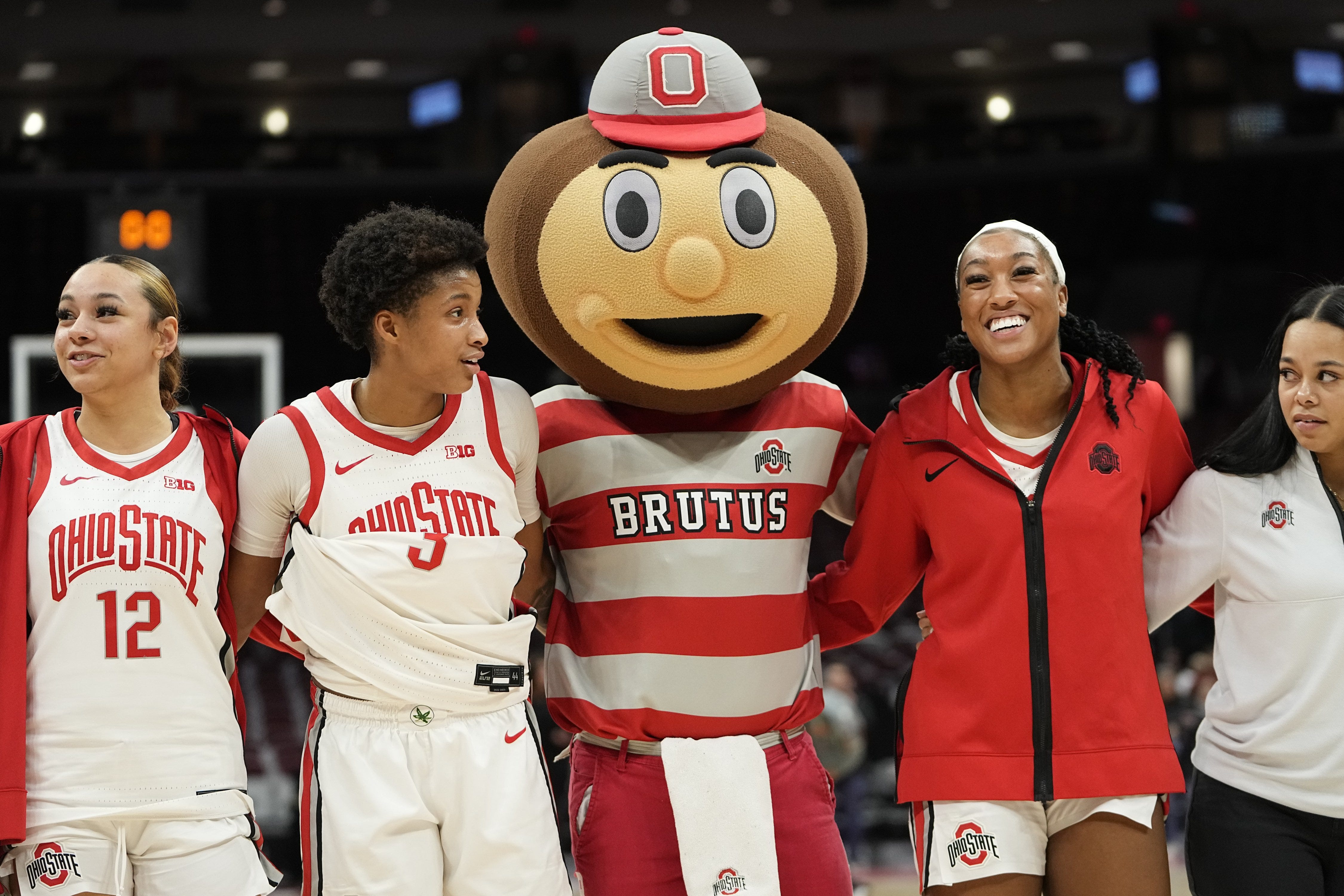 Jan 19, 2023; Columbus, OH, USA; Brutus Buckeye sings Carmen Ohio with arms around guard Hevynne Bristow (3) and forward Cotie McMahon (32) following their 84-54 win over the Northwestern Wildcats in the NCAA women's basketball game at Value City Arena