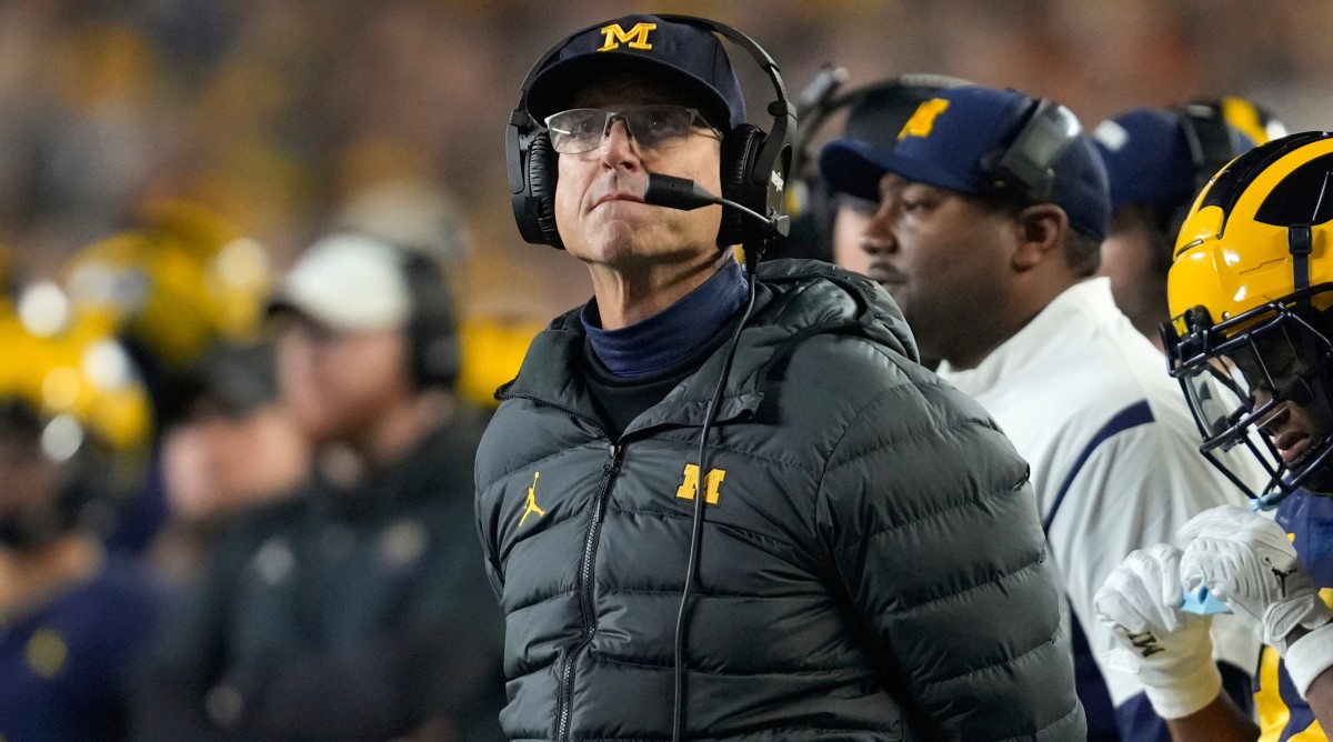 Michigan coach Jim Harbaugh looks on from the sidelines as his team plays against Purdue.