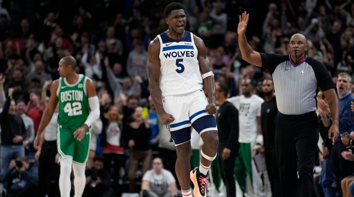 Timberwolves guard Anthony Edwards celebrates after making a shot in overtime of a game against the Celtics.