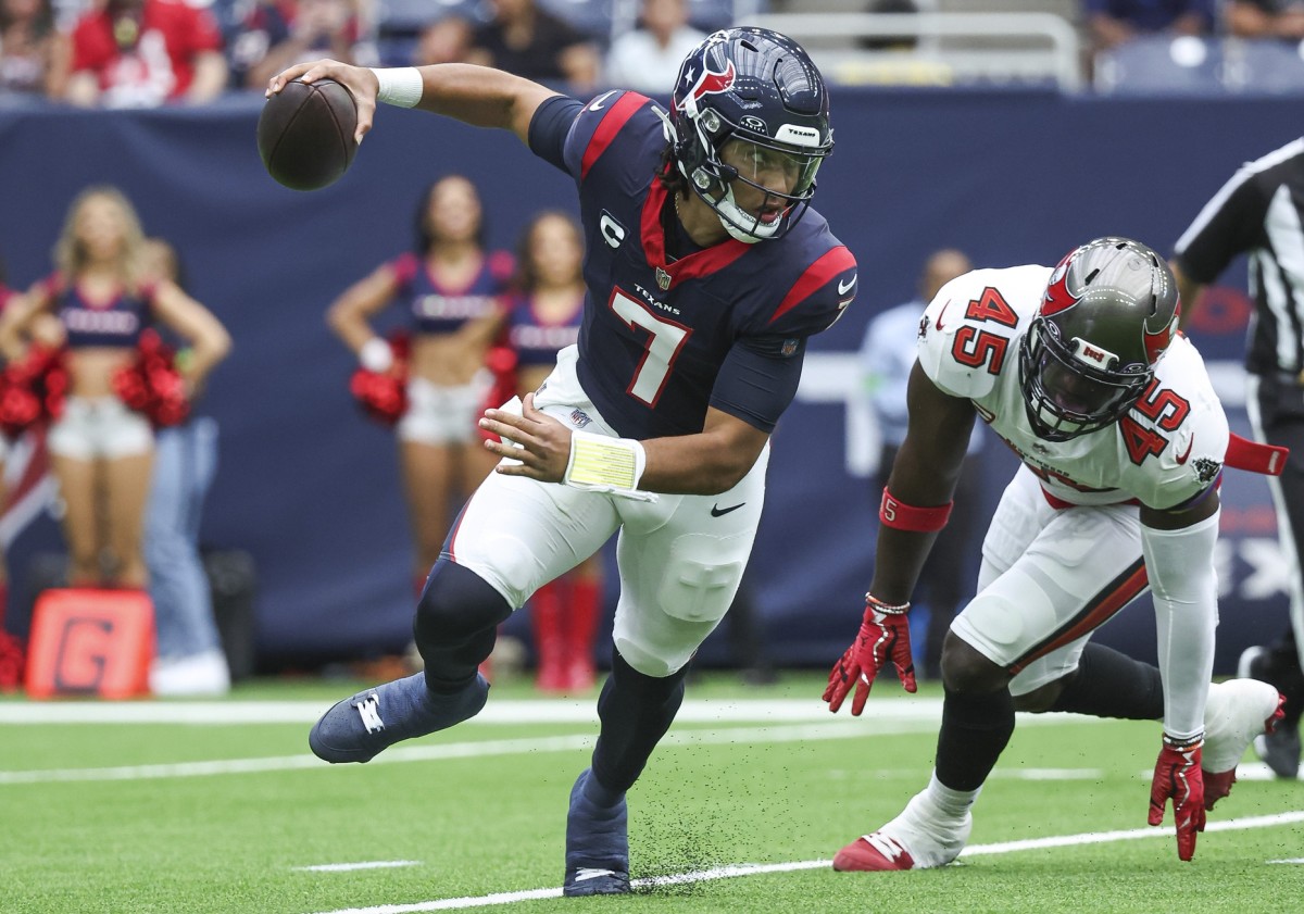 Houston Texans quarterback C.J. Stroud (7) scrambles with the ball as Tampa Bay Buccaneers linebacker Devin White (45) applies defensive pressure during the first quarter at NRG Stadium.