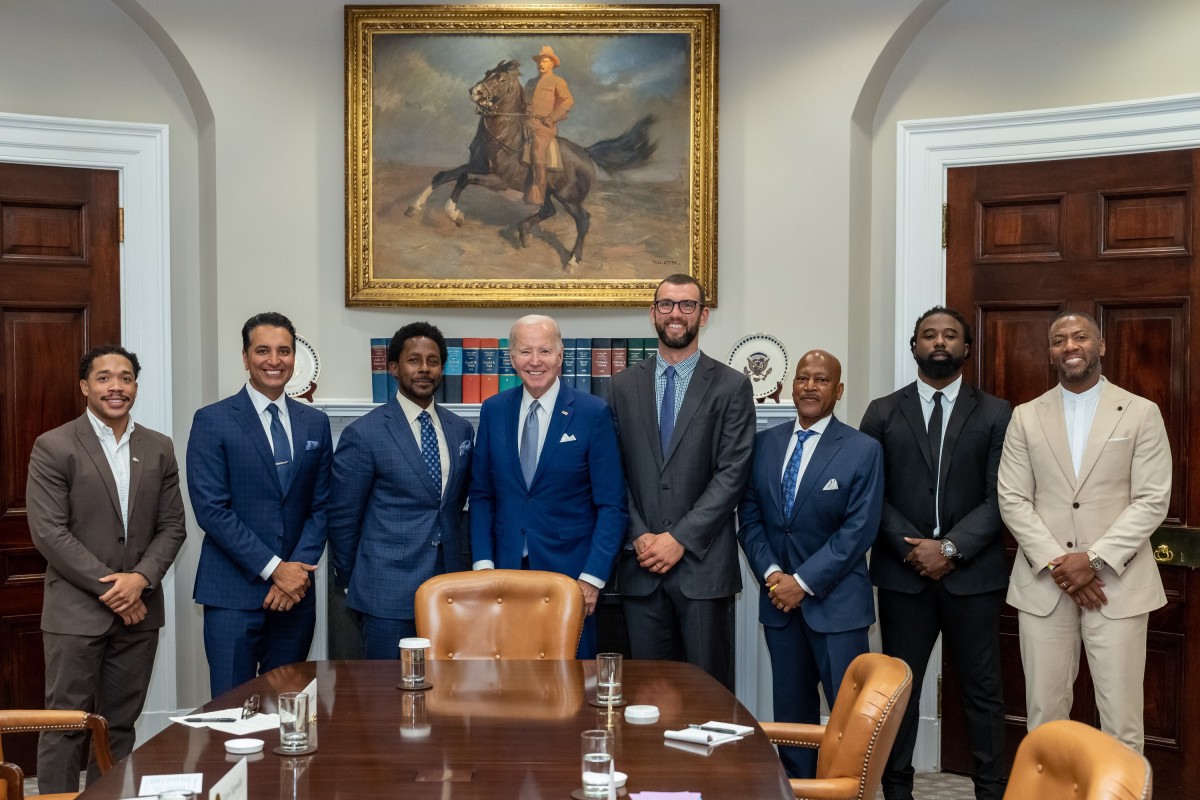 From left: Jordan Meachum, College Football Players Association representative; Kevin Negandhi, ESPN SportsCenter anchor;  Desmond Howard, 1991 Heisman Trophy winner and host of ESPN College Gameday; U.S. president Joe Biden; Former Stanford and Colts quarterback Andrew Luck; ESPN college football analyst Rod Gilmore; Keith Marshall, former Georgia running back and Co-Founder/CEO of the Players' Lounge; Former LSU and Steelers safety and current ESPN analyst Ryan Clark