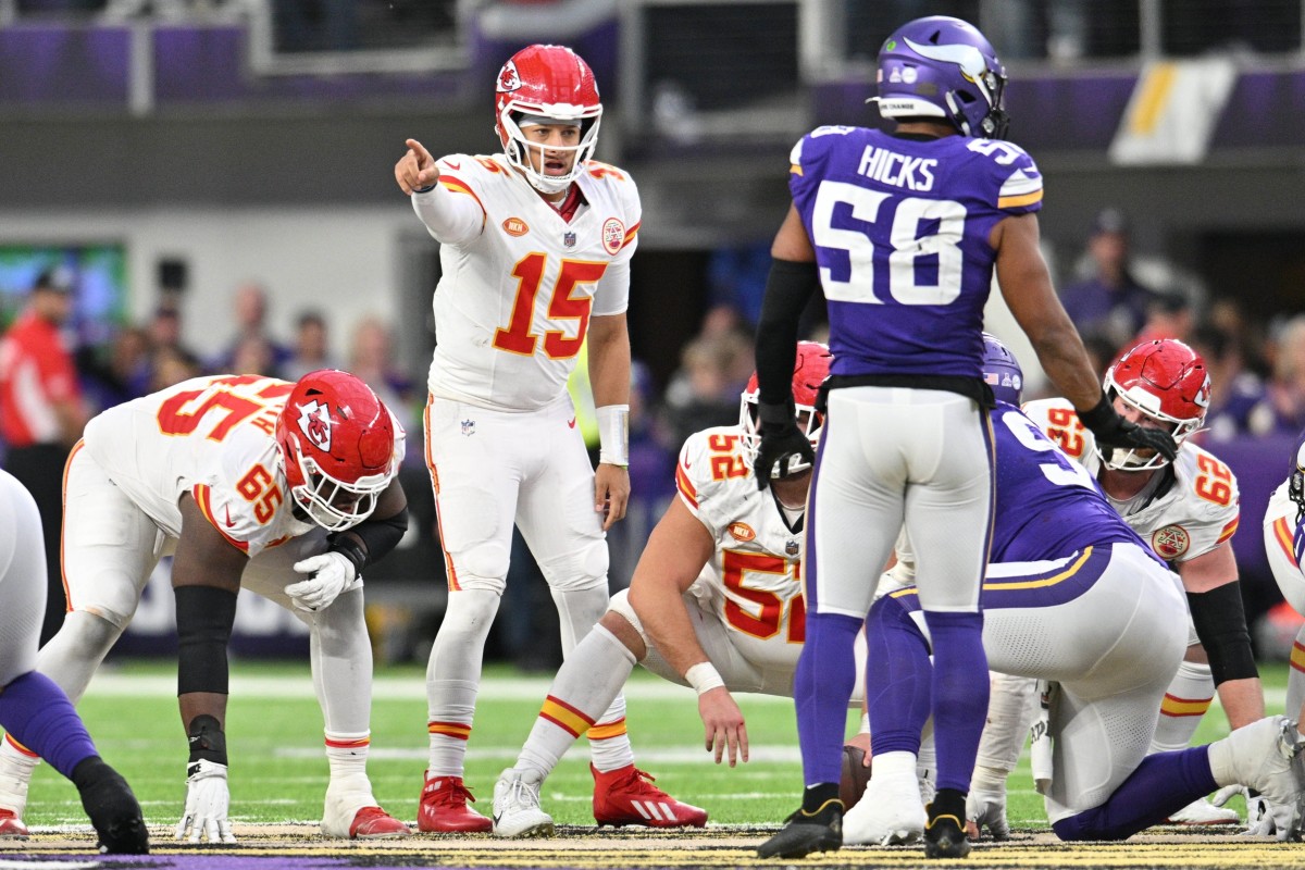 Oct 8, 2023; Minneapolis, Minnesota, USA; Kansas City Chiefs quarterback Patrick Mahomes (15) directs the offense as guard Trey Smith (65) and center Creed Humphrey (52) and Minnesota Vikings linebacker Jordan Hicks (58) look on during the fourth quarter at U.S. Bank Stadium. 