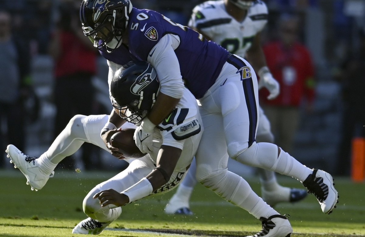 Baltimore Ravens linebacker Kyle Van Noy (50) sacks Seattle Seahawks quarterback Geno Smith (7) during the first half at M&T Bank Stadium.