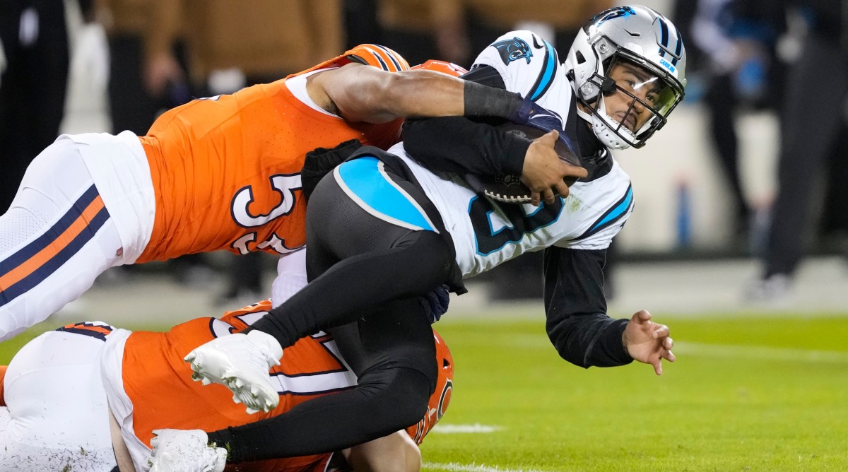 Panthers quarterback Bryce Young (9) is tackled by Bears linebacker T.J. Edwards (53) during the first half of a game.