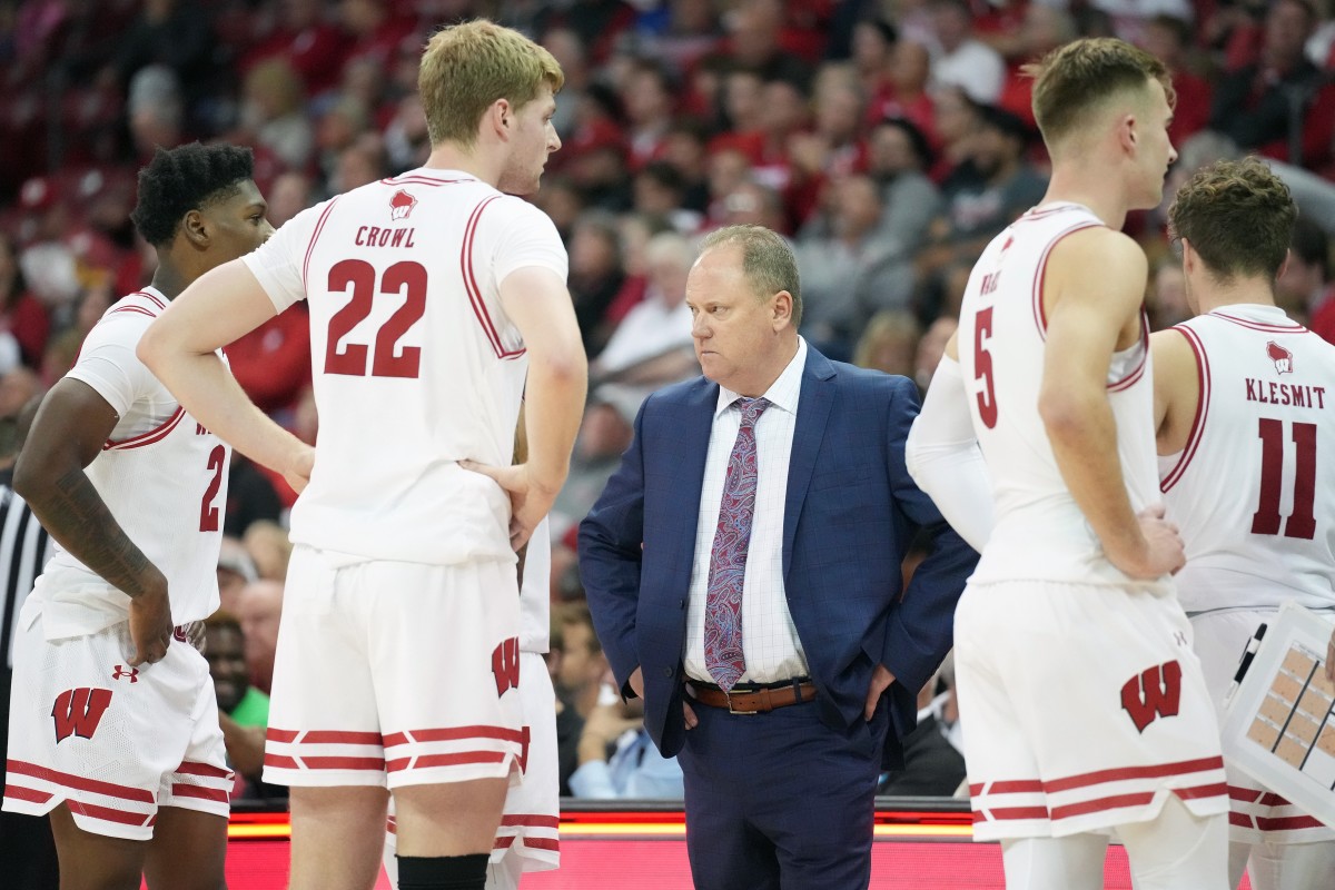 Nov 6, 2023; Madison, Wisconsin, USA; Wisconsin Badgers head coach Greg Gard (center) huddles with his team during a timeout during the second half against the Arkansas State Red Wolves at the Kohl Center. Mandatory Credit: Kayla Wolf-USA TODAY Sports