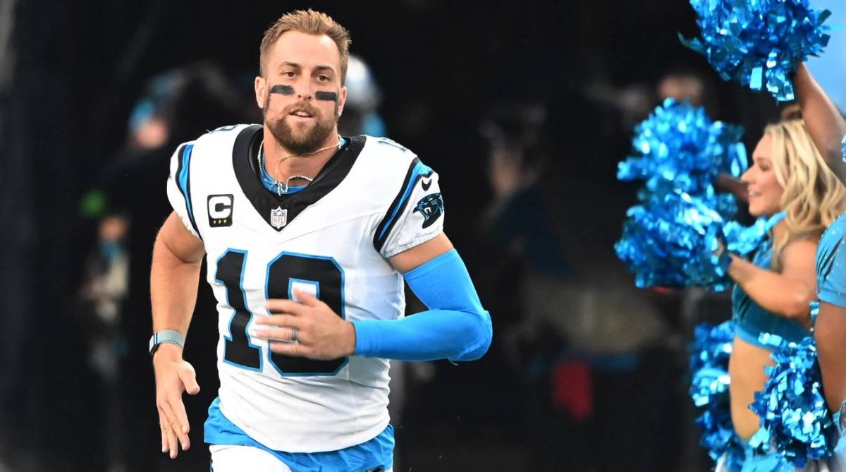 Panthers wide receiver Adam Thielen runs through the tunnel out onto the field before a game.