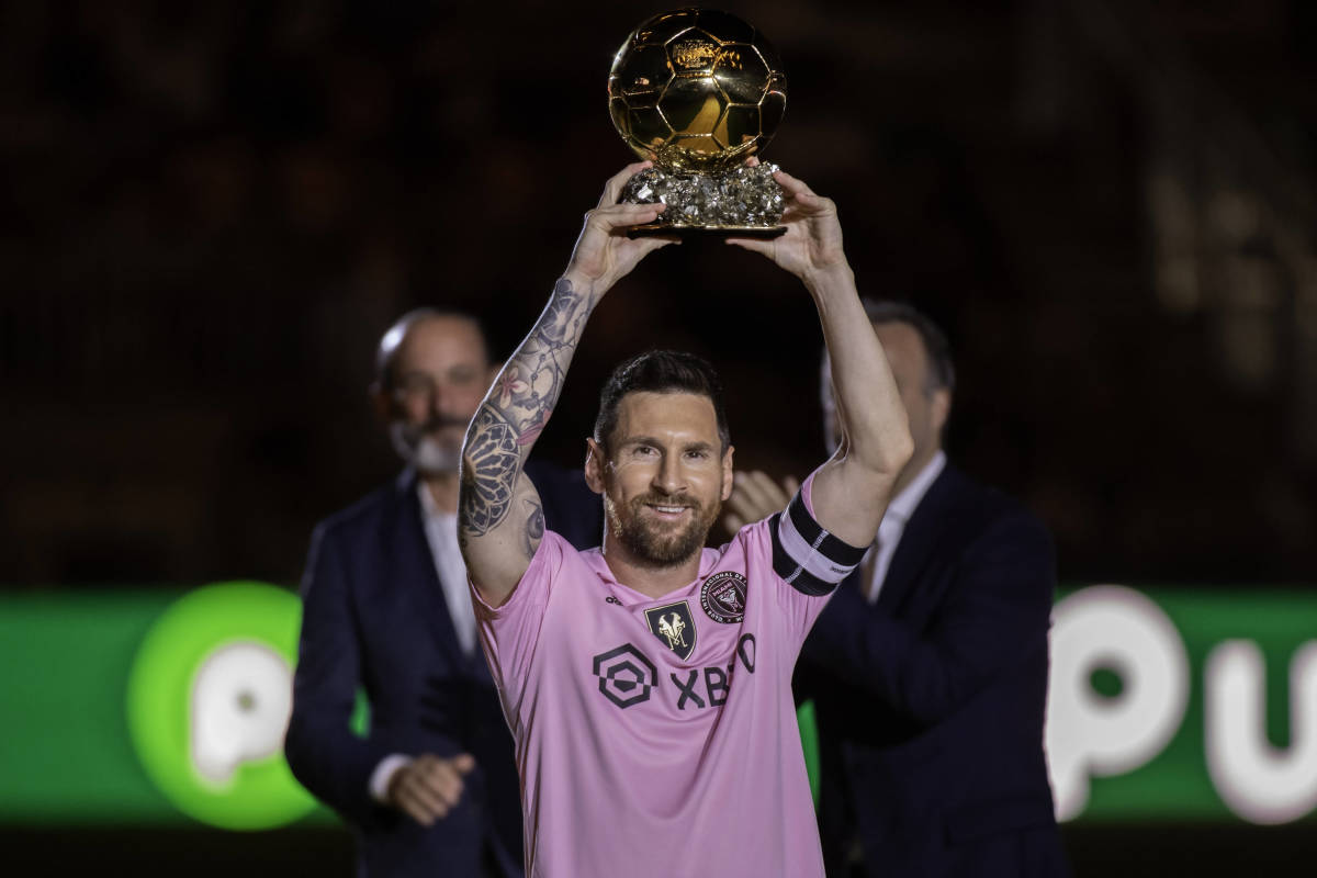Inter Miami captain Lionel Messi pictured lifting his Ballon d'Or trophy at a celebration event at DRV PNK Stadium in November 2023