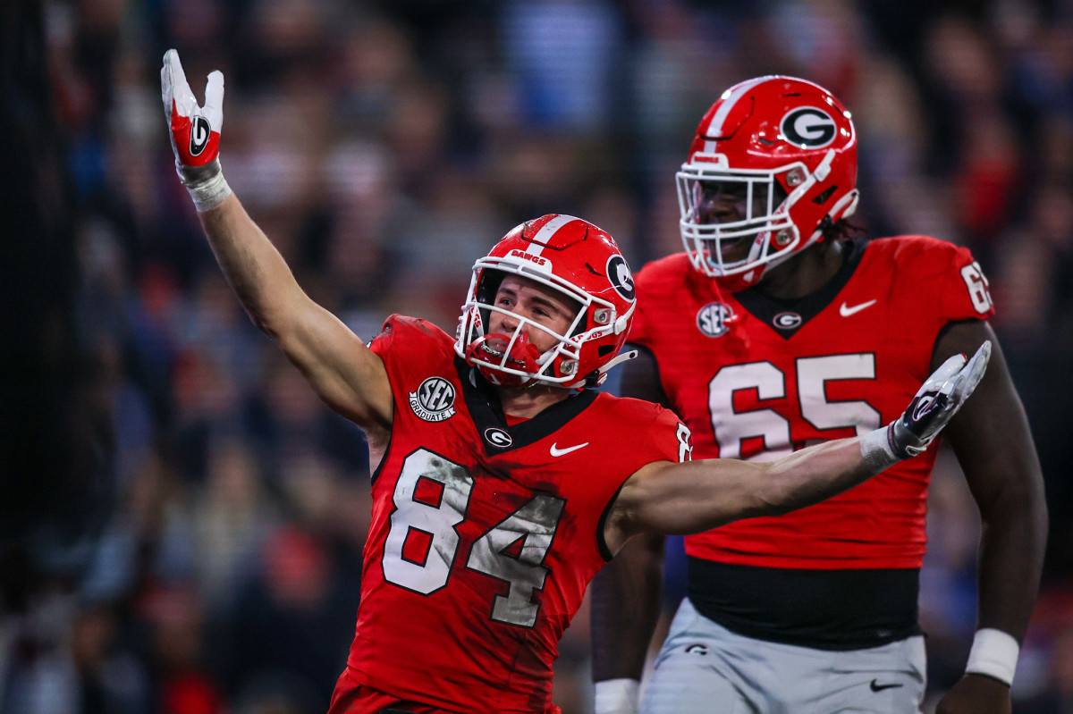 Georgia Bulldogs wide receiver Ladd McConkey (84) celebrates after a touchdown with offensive lineman Amarius Mims (65) against the Mississippi Rebels in the first quarter at Sanford Stadium.
