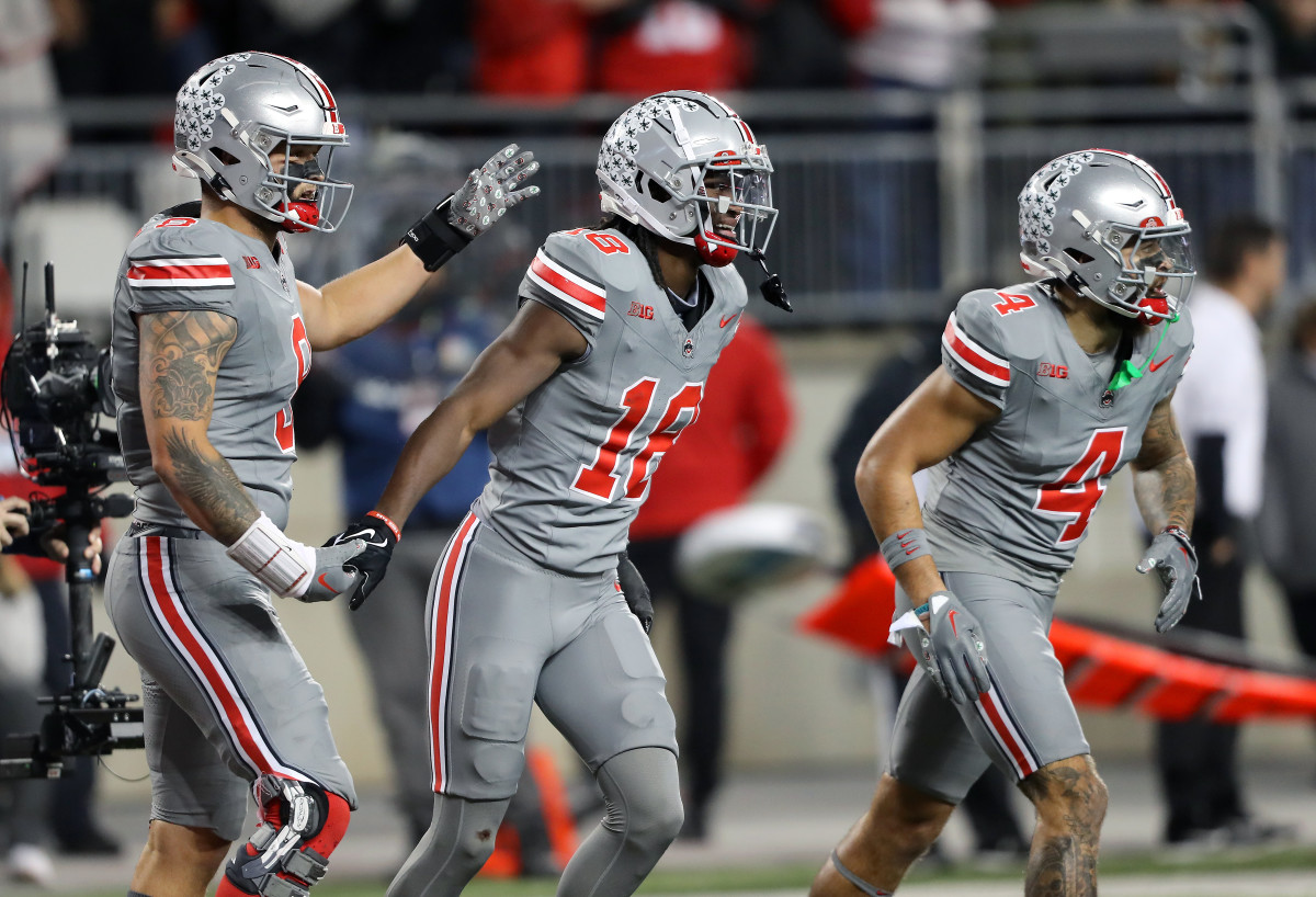 Ohio State Buckeyes wide receiver Marvin Harrison Jr. (18) celebrates the touchdown with tight end Cade Stover (8) and wide receiver Julian Fleming (4) during the first quarter against the Michigan State Spartans
